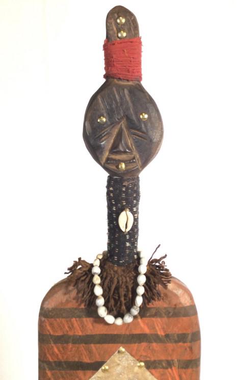 Signed African Namaji Fl. Sz. Wood Doll, Nigeria: West African Sculptural Wood Doll Figural. Hand carved and painted red & yellow ceremonial skirt, washed patina stripe pattern upper body. Accented with metal decor, including rounded brass tacks for 