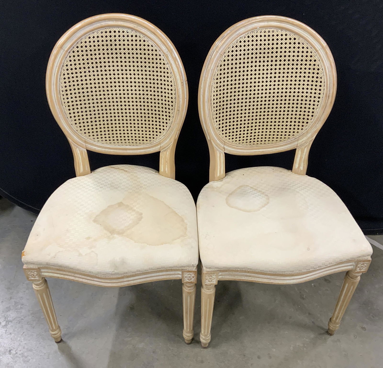 Set 4 Vintage Wooden Dining Room Chairs: This is set of four vintage dining room chairs. The seats are upholstered and the backs are crafted from wicker, the chair legs are fluted. Flowers are carved into the top of the two front chair legs.