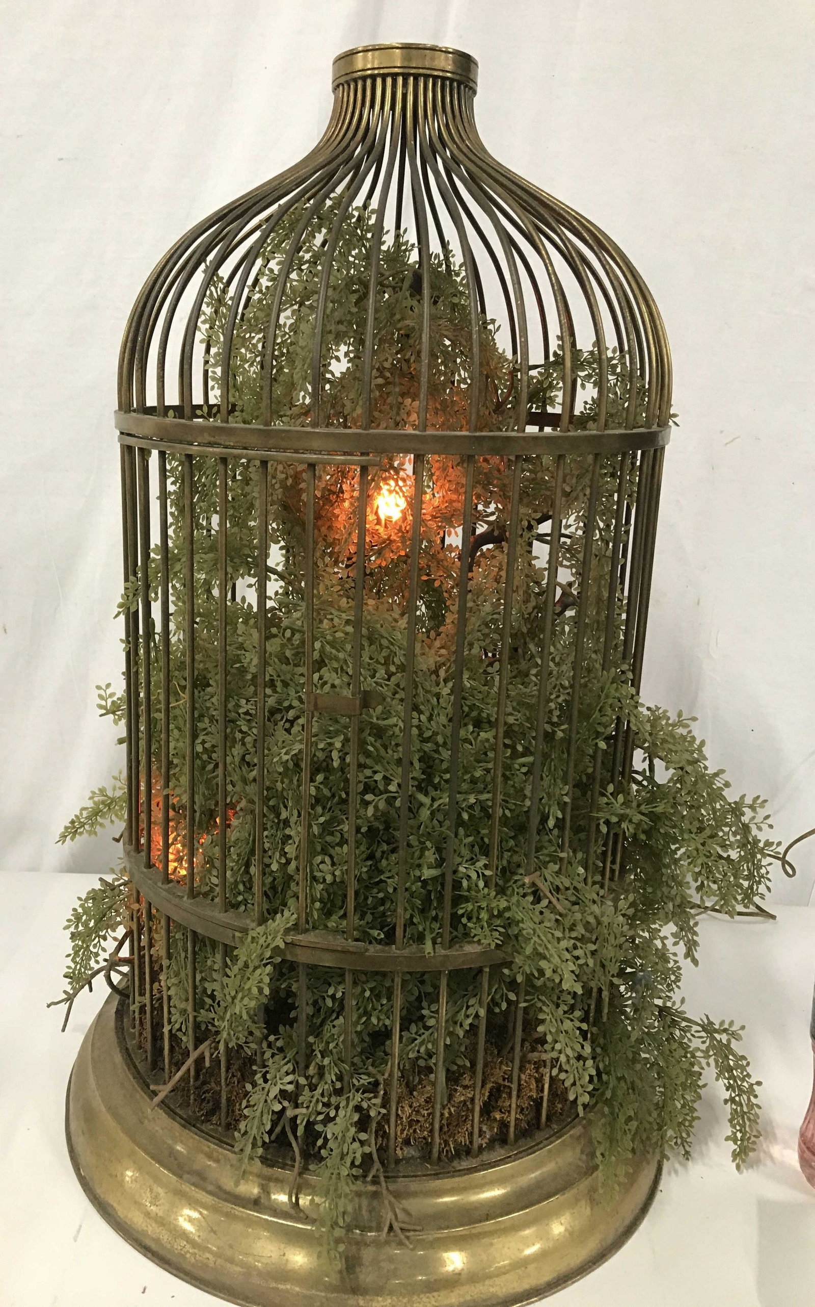 Vintage Oversized Brass Lighted Birdcage: Tall Brass Birdcage, currently with faux greens & moss on top of styrofoam, and lit with orange lightbulbs (2 are working, there are at least a few lightbulbs) via cord that has on/ off switch on cord