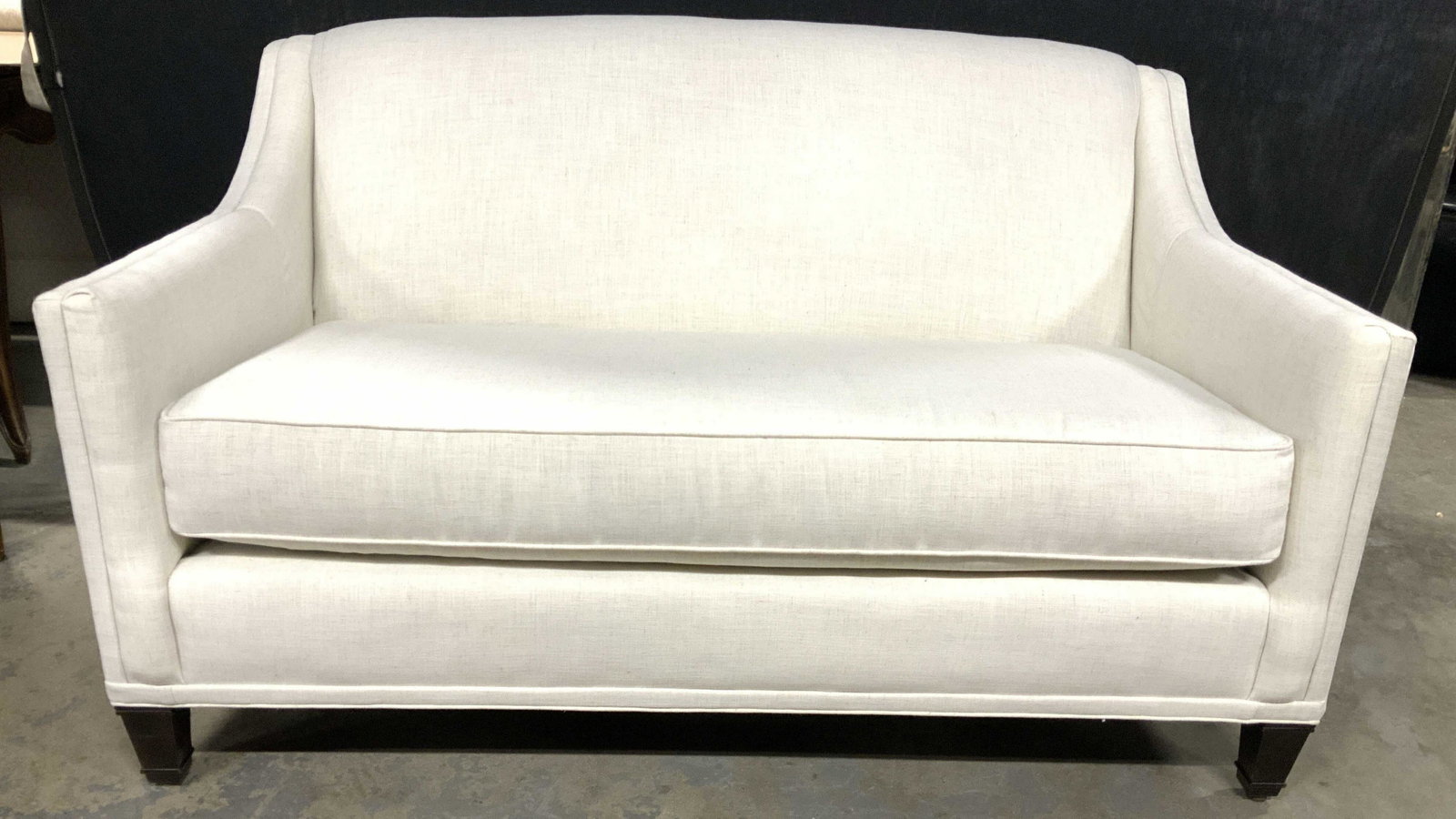 COUNTRY WILLOW Off White Toned Loveseat: Loveseat has tag which reads COUNTRY WILLOW. Loveseat has off white tone. Piece has dark chocolate toned feet. Piece has single cushion. Piece measures approximately 57 inches long 34 inches deep and 