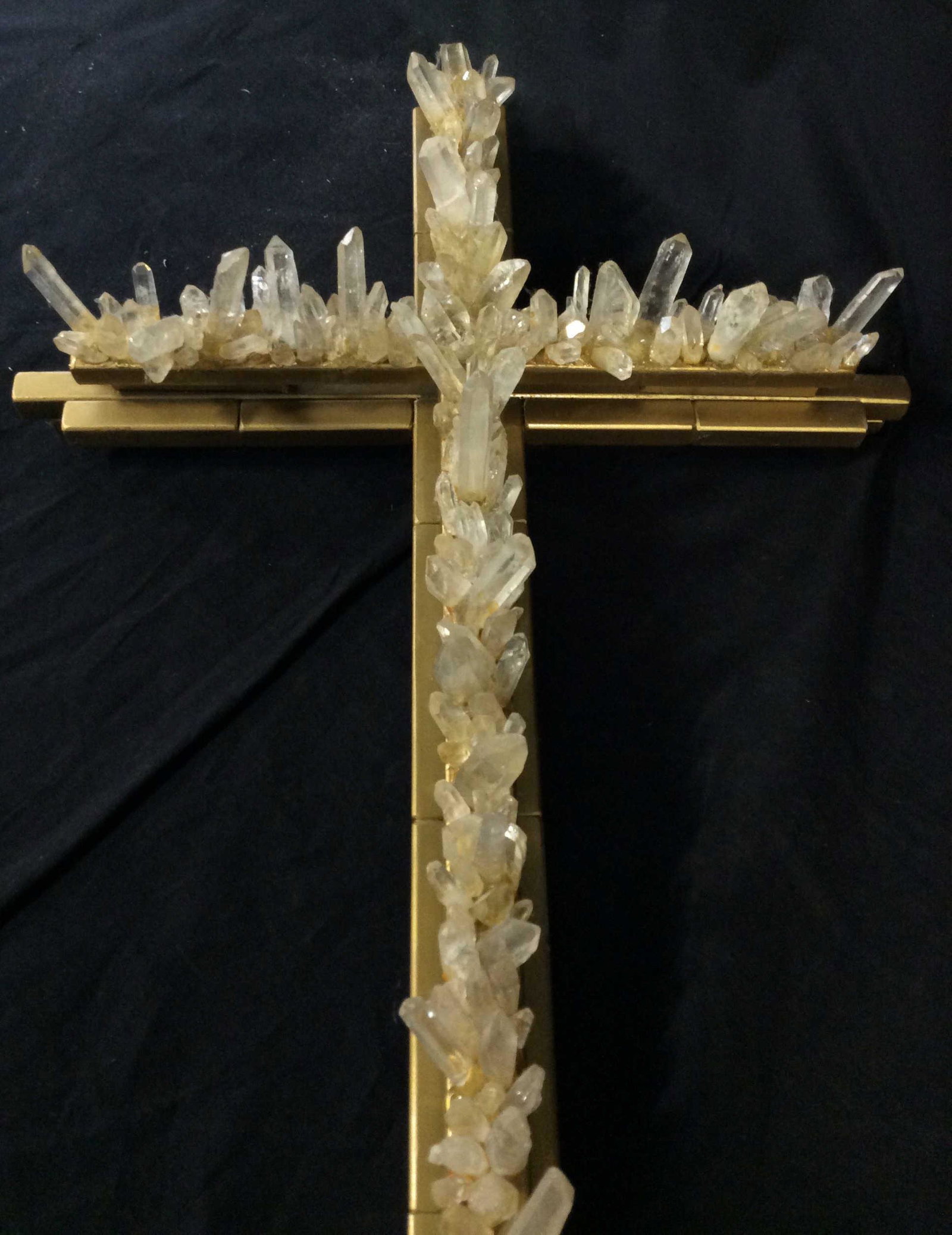 Signed Grand Quartz Crystal & Metal Wall Cross: Metal sculpture cross, handmade by artist and signed ‘D. Larson 2012’ in verso. Sprayed with metallic gold paint over metal with 2 in. + long quartz crystals (sizes vary) decorating front of the c