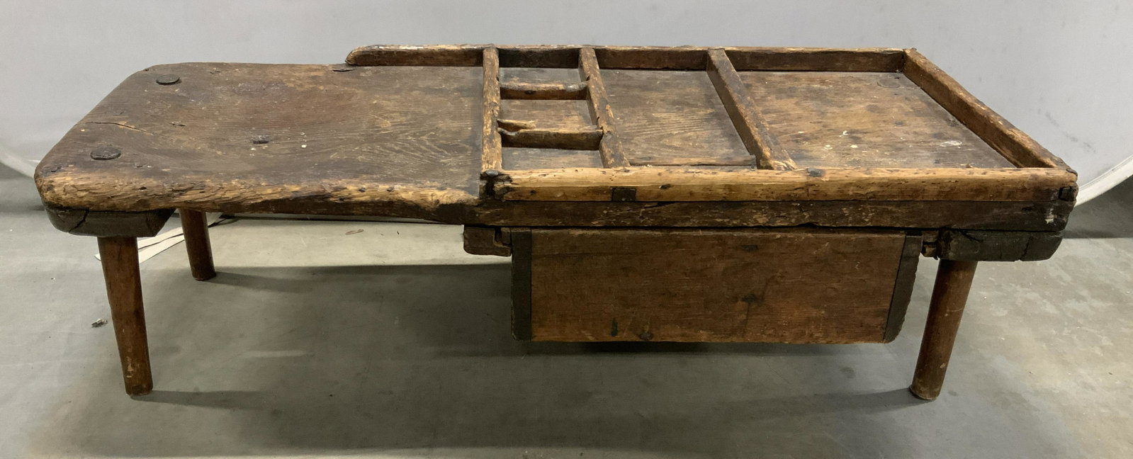 Antique Handmade Cobblers Work Bench: This is an antique coffee table. The piece is handmade and is crafted from wood. The piece includes a drawer, the drawer is removable. The piece measures approx 13 inches H, 45 inches W, and 19 inches