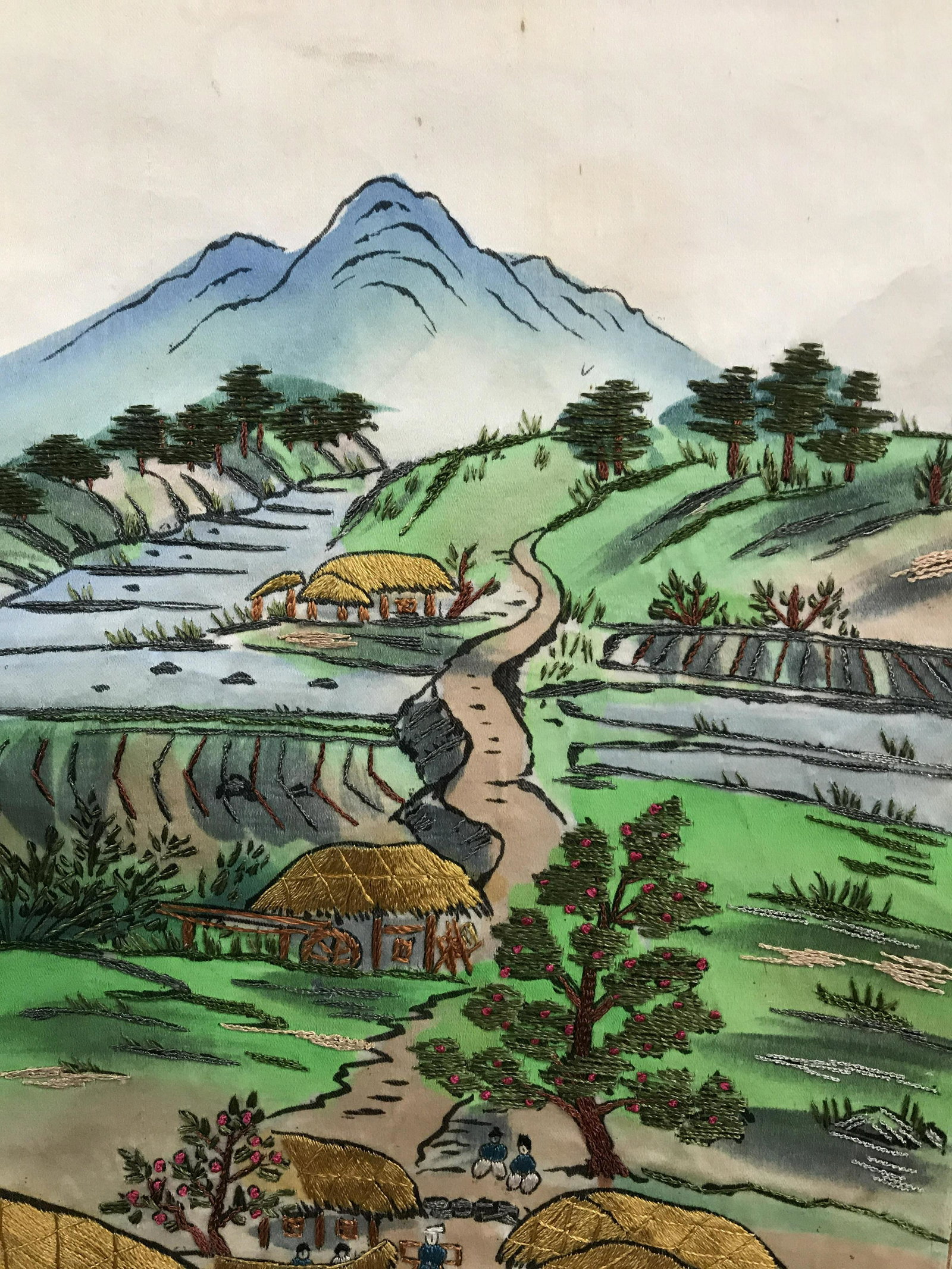 Embroidered Korean Scroll Of Village Scene: Hand embroidered scroll, Brocade fabric paper border. Scroll measures 39 x 12 1/4 in. Heavy threading/ embroidery, including background. Thread possibly silk. Light blemishes on front consistent with 