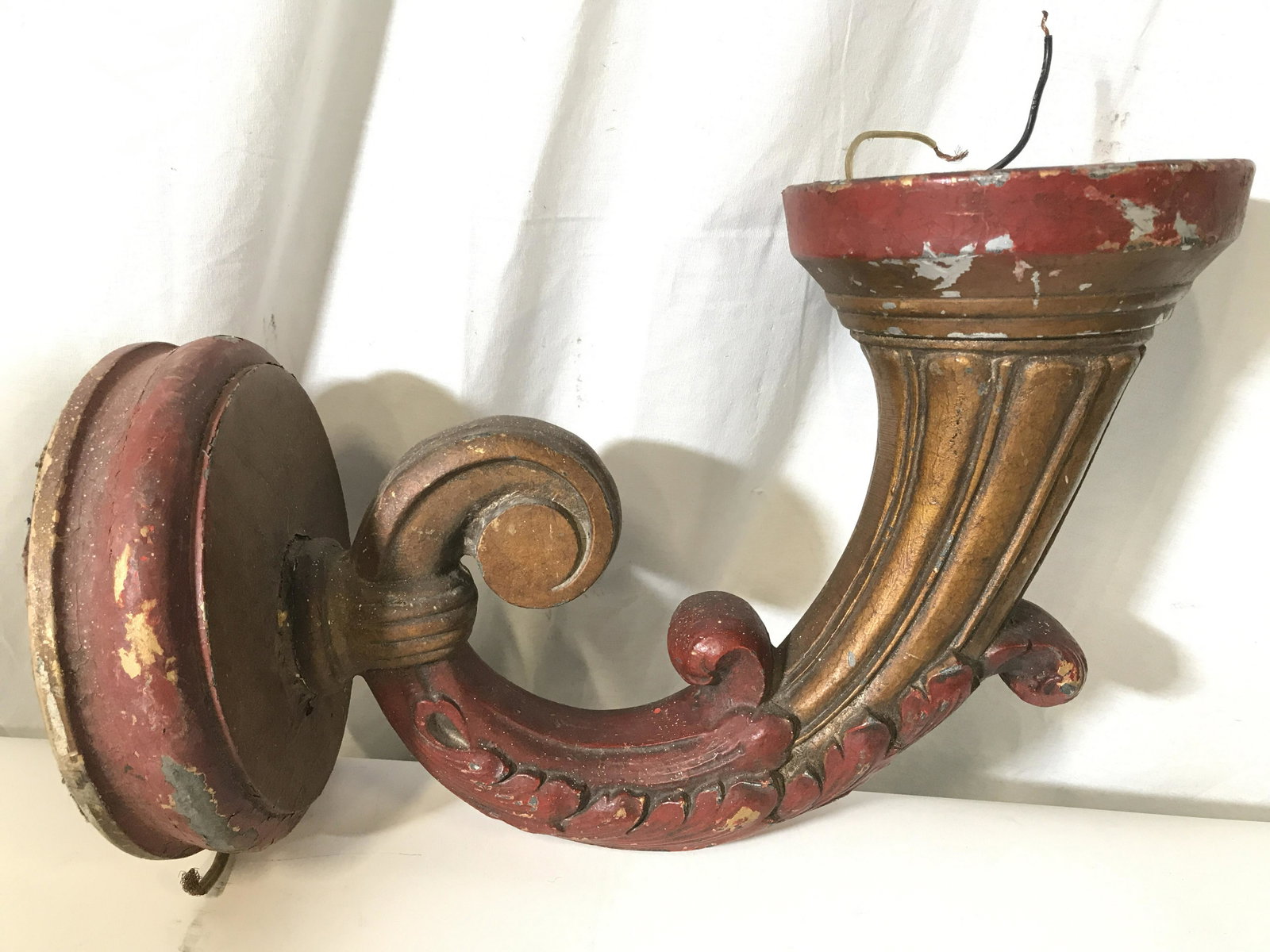 Pair Vintage Painted Metal Ornate Wall Sconces: Lot includes 2 wall sconces. Each have tones of red and gold. Pieces have ornate c curve detail. Pieces measure approximately 11 inches tall 16 inches deep 8 inches wide. Light fixtures are vintage. M