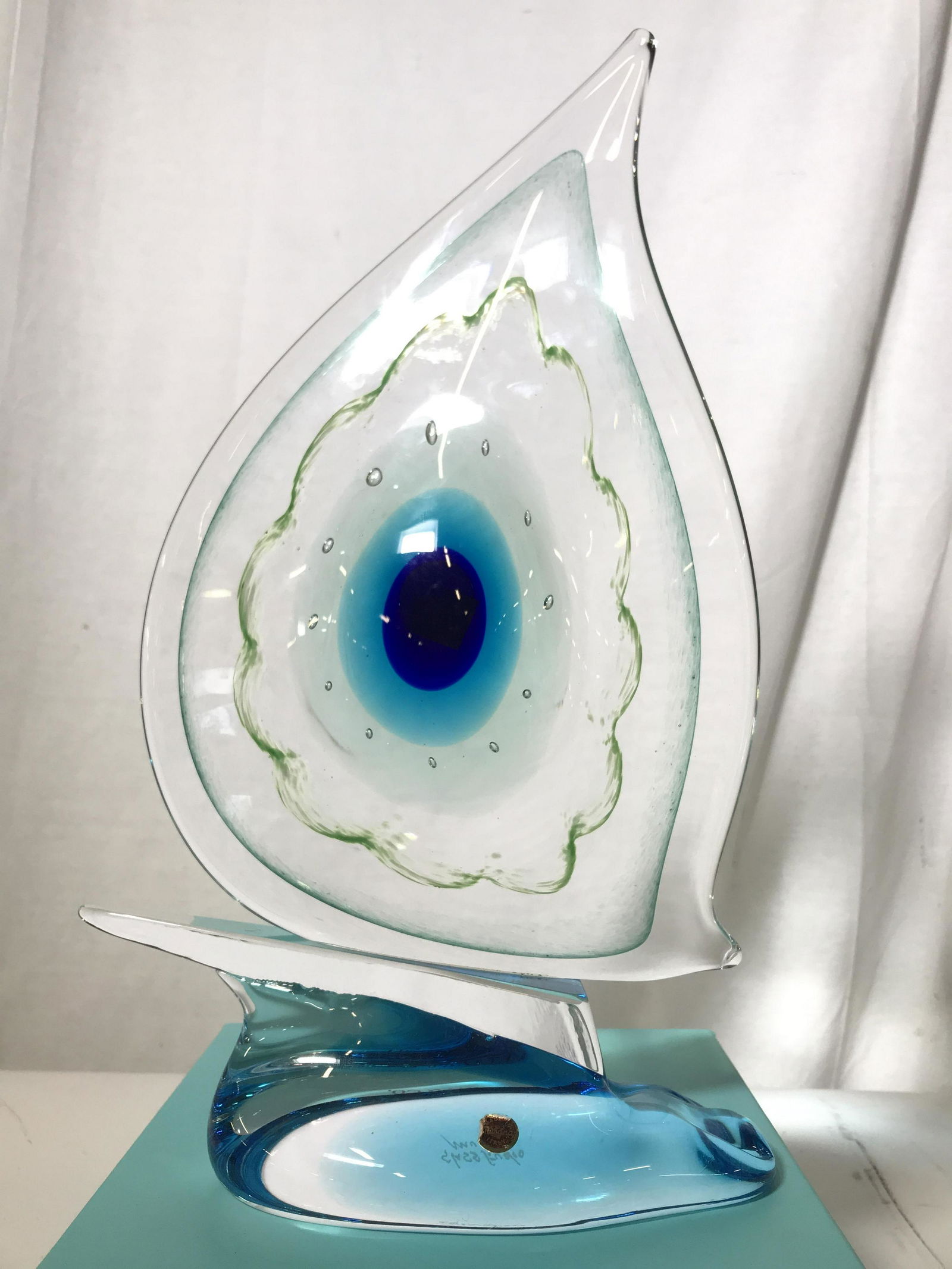 Signed MURANO Art Glass Sail Boat Form: Signed MURANO Art Glass Sail Boat Form with blue, green and bubble design, etched on underside Glass Studio Murano, red and gold toned Made In Italy Murano Sticker on side, measures approximately 15 i