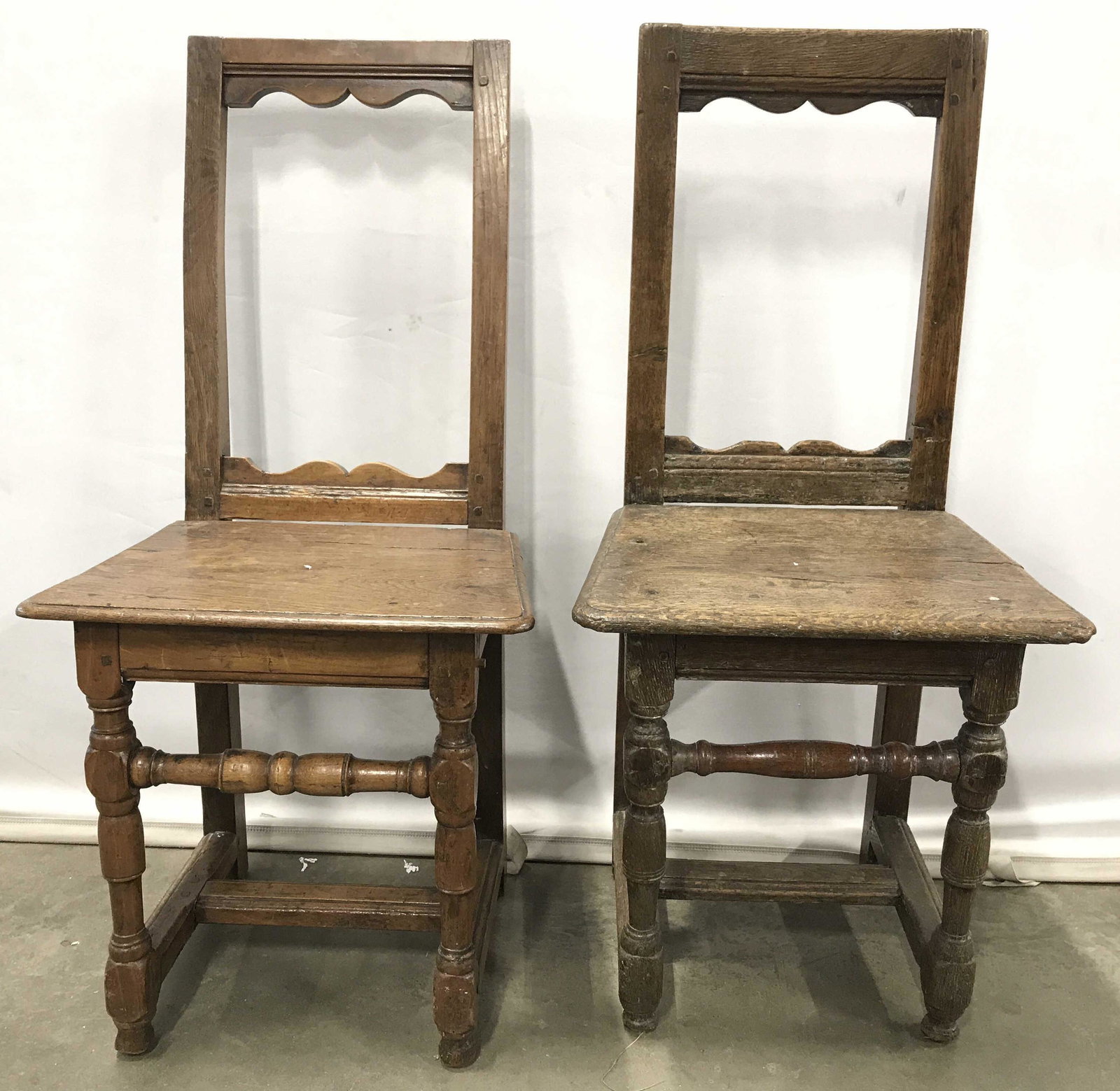 Lot 2 Vintage Wooden Children’s Side Chairs: Chairs are vintage possibly antique. Side chairs are wooden. Pieces have carved wooden detail. Chairs differ slightly in structure. Legs have stretchers. Pieces measure approximately 34 inches tall 16