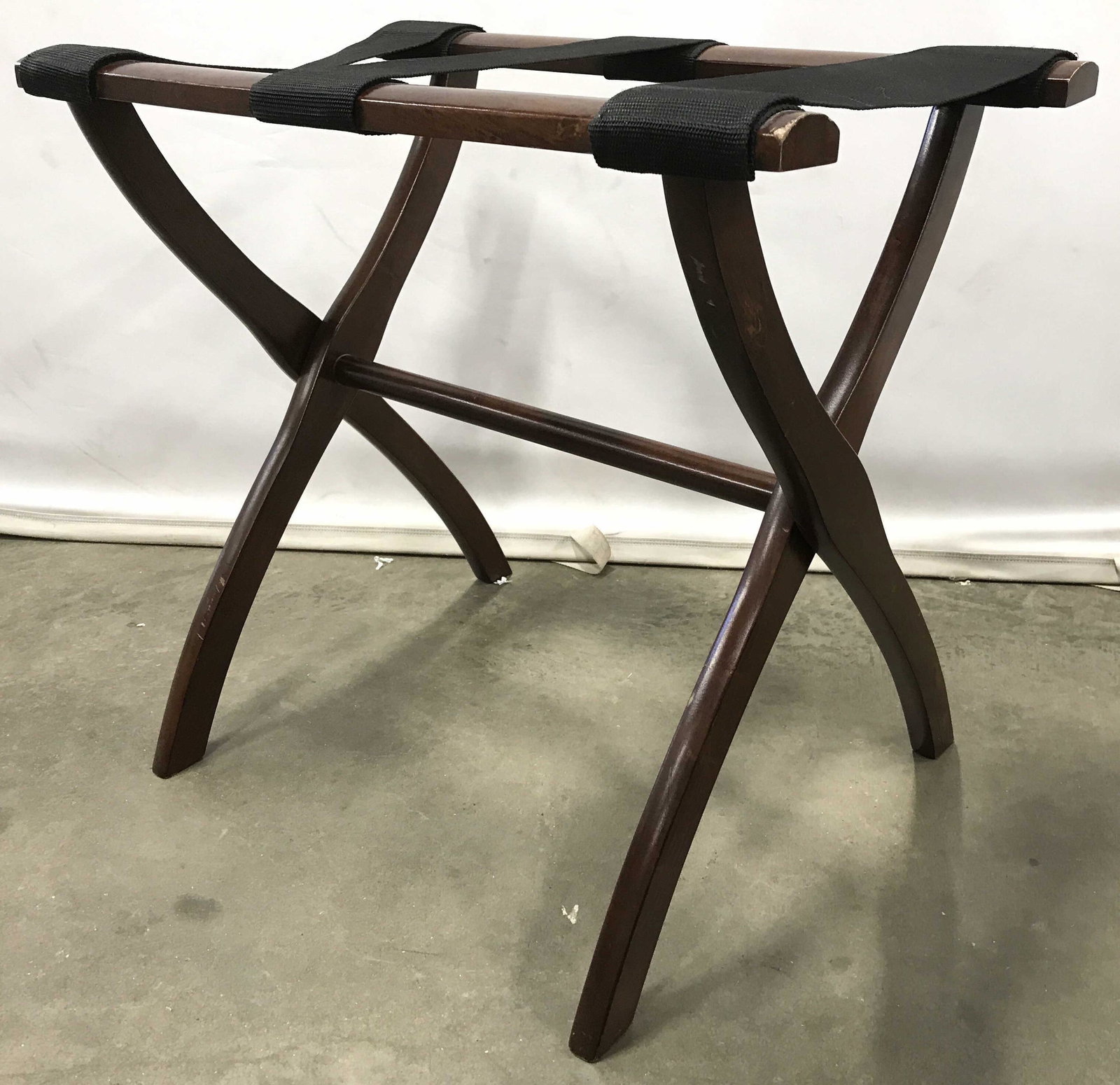 Vintage Carved Wooden Luggage rack: Luggage rack is wooden. Piece has 3 black toned support bands. Piece is possibly mahogany. Luggage rack, luggage stand, suitcase stand, suitcase rack. Piece measures approximately 20 inches tall 23 in