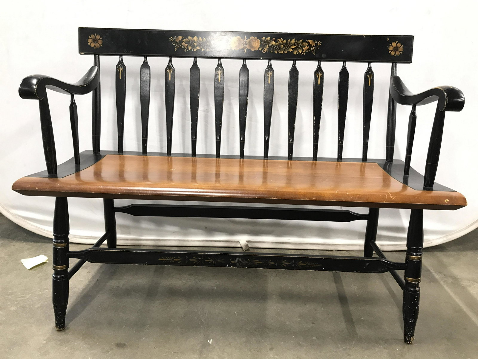 Vintage Painted Carved Wooden Bench: Bench appears to possibly be hand painted. Piece is Vintage Possibly antique. Bench has spindle like back rest. Bench has armrests. Top of backrest has painted floral & leaf detail. Bench legs have st
