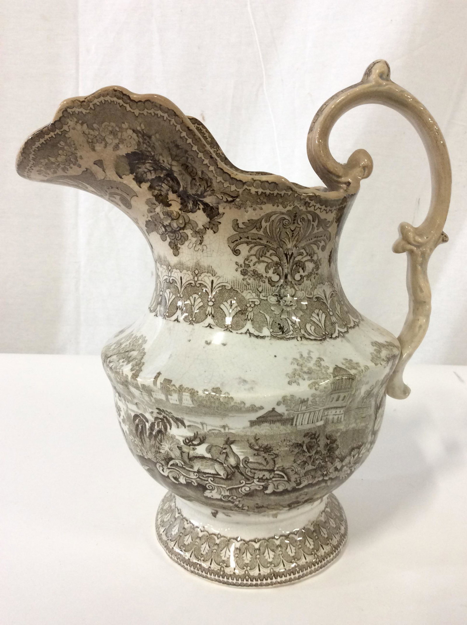 W&C STAG Porcelain Stoneware Pitcher: Underside of piece is marked W&C STAG. Piece has intricate dark chocolate toned detail. Porcelain pitcher, Stoneware Pitcher, Pitcher, Ornate Pitcher, Tableware, Tabletop Accessories. Piece measures a