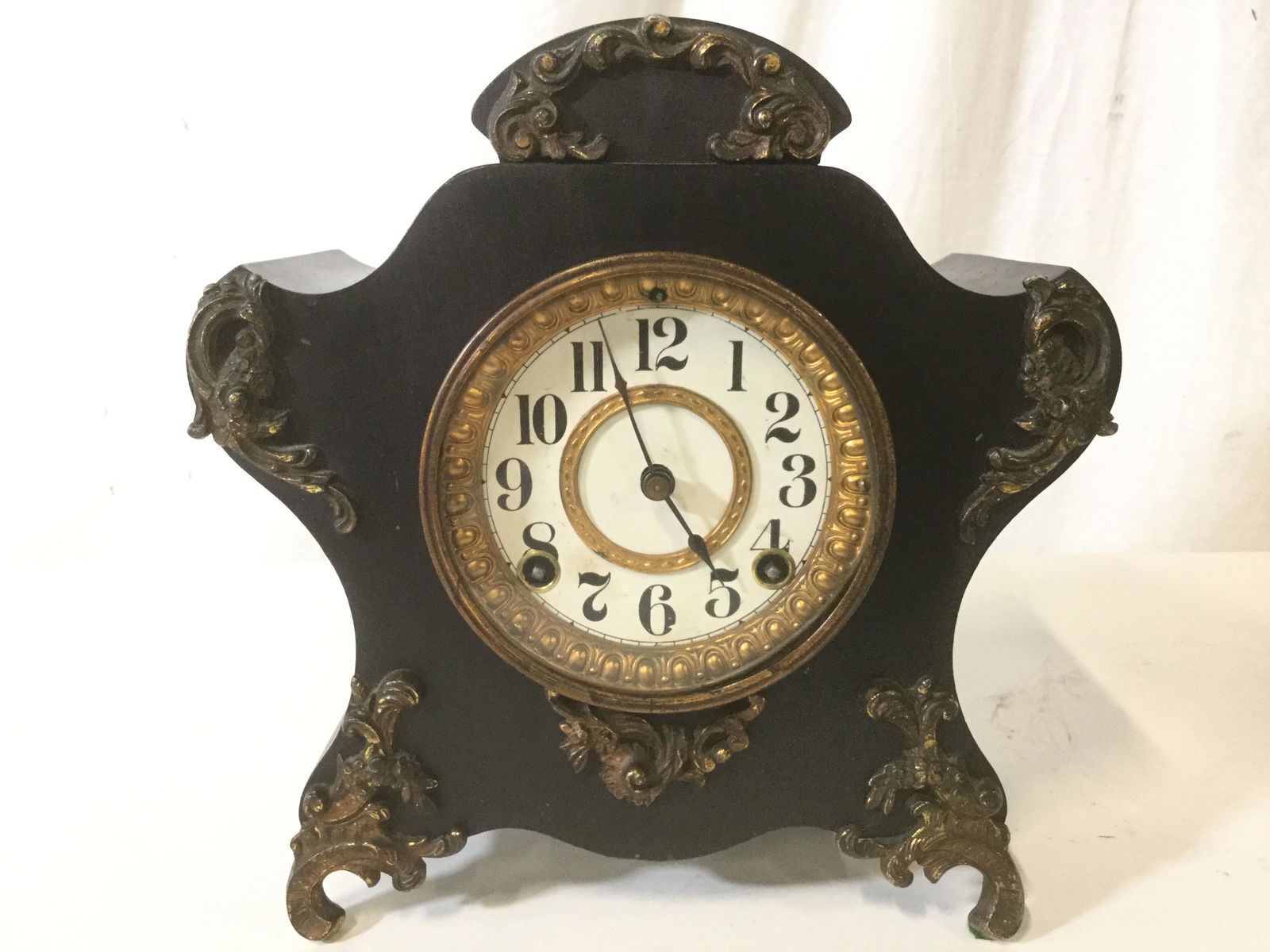 ANSONIA CLOCK CO Vintage Ornate Mantel Clock: Interior of piece is marked ANSONIA CLOCK CO USAPiece appears to be metal and brass. Piece has gold toned ornate detailings. Piece has white Toned clock face with black toned numericals . Vintage cloc