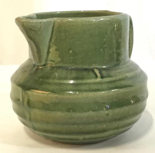 Nelson McCoy Green Stoneware Buttermilk Pitcher: Vintage Nelson McCoy Green Stoneware Buttermilk Pitcher with Shield Hallmark Moss Green Color, painted & glazed inside & out. Rounded stout pitcher, 5 in. Ht. 6 3/4 in. width. Opening 4.5 in. includin
