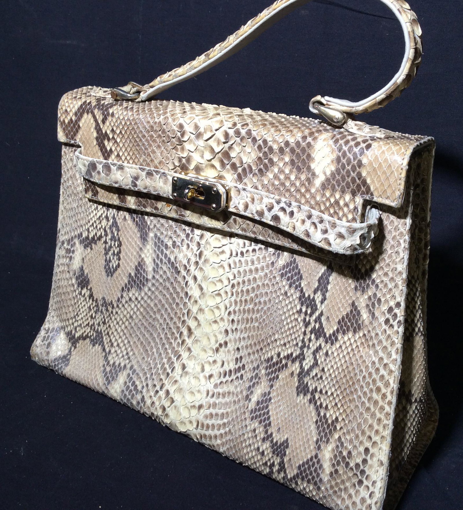 Genuine Leather Snakeskin Handbag, Italy: Snakeskin Bag, can feel the scales, Bag Made in Italy, interior flap genuine white leather. 1 carry handle. Twist lock closure, gold tone hardware accessories. Interior beige cotton weave, mild blemis