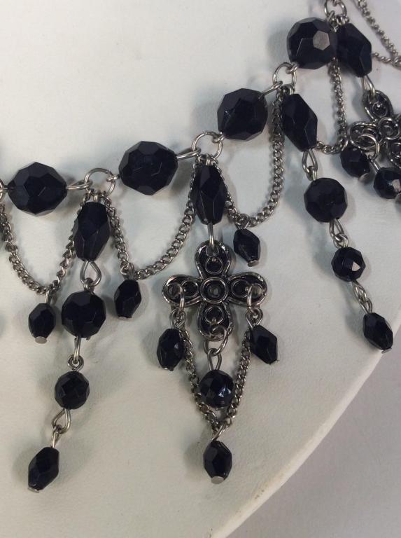 Black Beaded Gothic Victorian Style Necklace: Black beaded Gothic Victorian Style Collar Necklace. Necklace has silver toned chain with black beads and velvet fabric tie closure. Necklace strand approximately 13 inches in length, can be adjusted.
