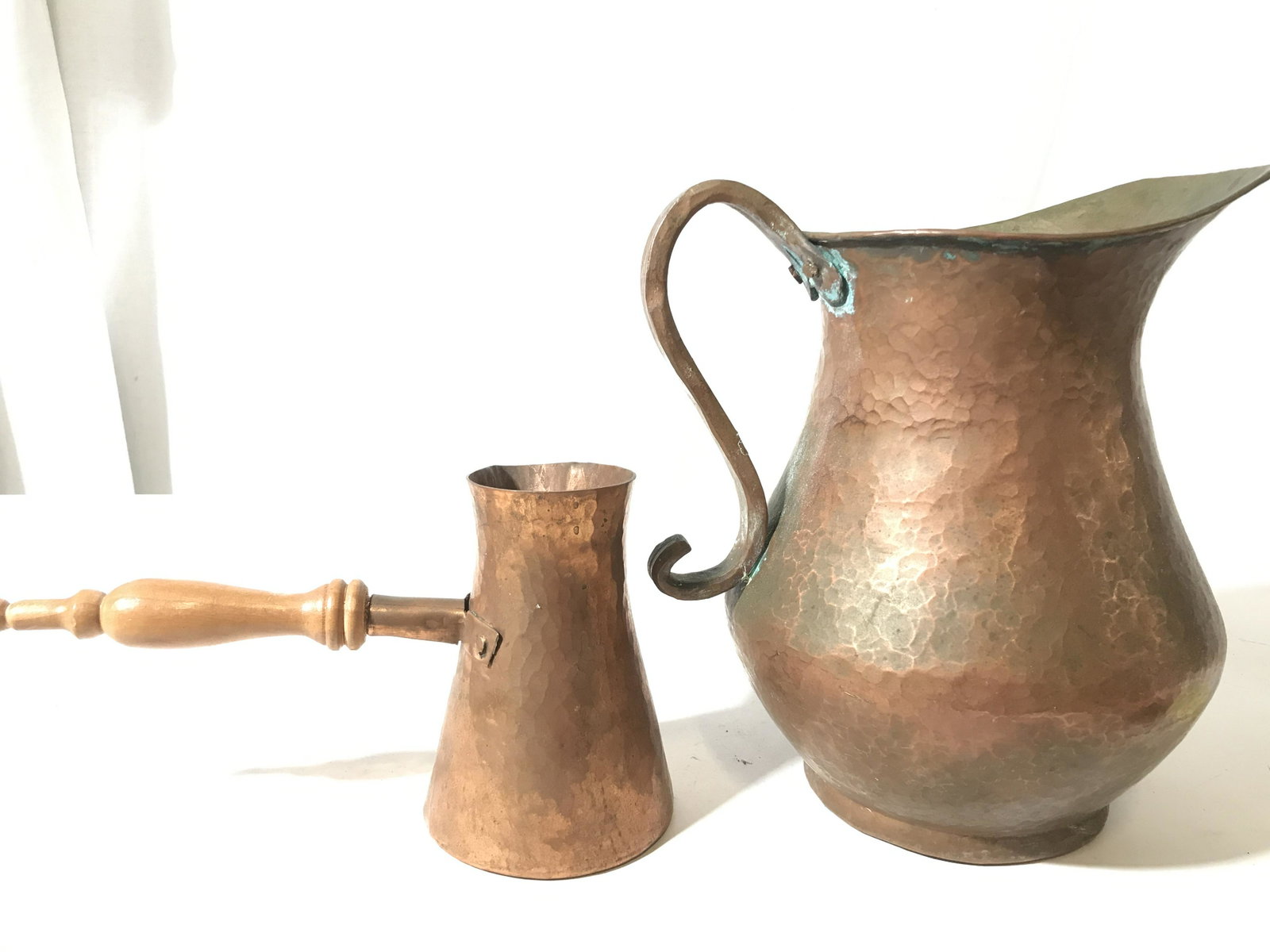 Lot 5 Copper Vessels & Accessories: This lot includes several copper vessels, this includes, a pitcher, a spittoon, a pourer, a bottle, and a copper strainer. The largest piece measures approx 9.5 inches H, and 8.5 inches W. The undersi