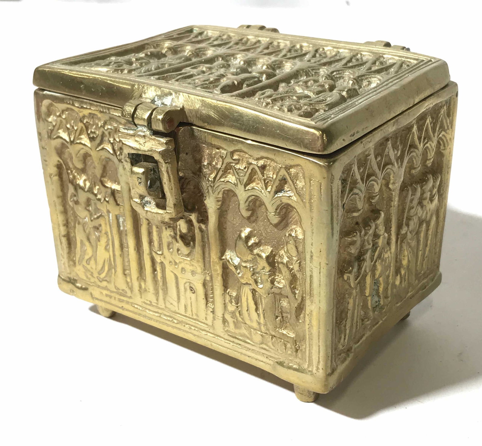 Intricately Detailed Brass Keepsake Box: This is a brass trinket box. The piece is decorated with intricate detailing, the detailing is done in relief. The piece measures approx 3.5 inches H and 4 inches W. There is wear present on the box c