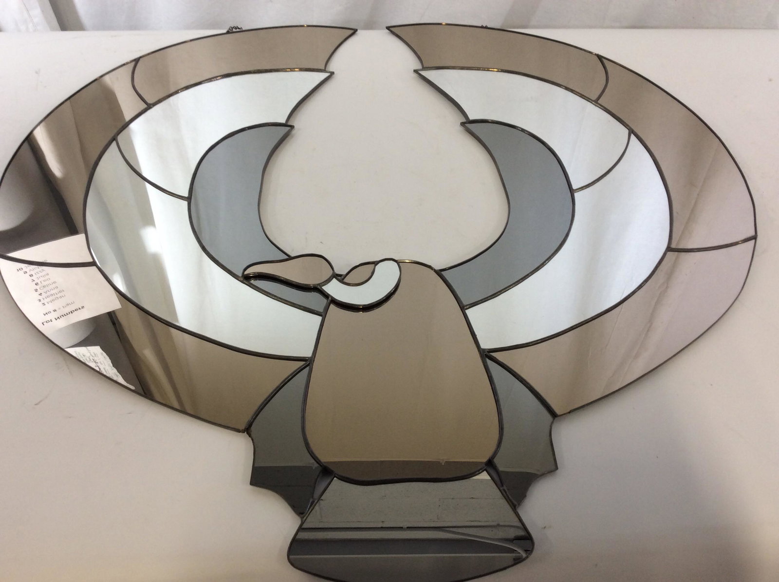 Oversize Mirrored Wall Light Catcher: Multi panel mirrors creating a Condor or Vulture Bird Figural. Long chain attached to hang approx 2 ft long). Mirror in colorful shades of sepia, Clear, & Grey Metallic. App 32 in. wide, 29 3/4 in. Ht