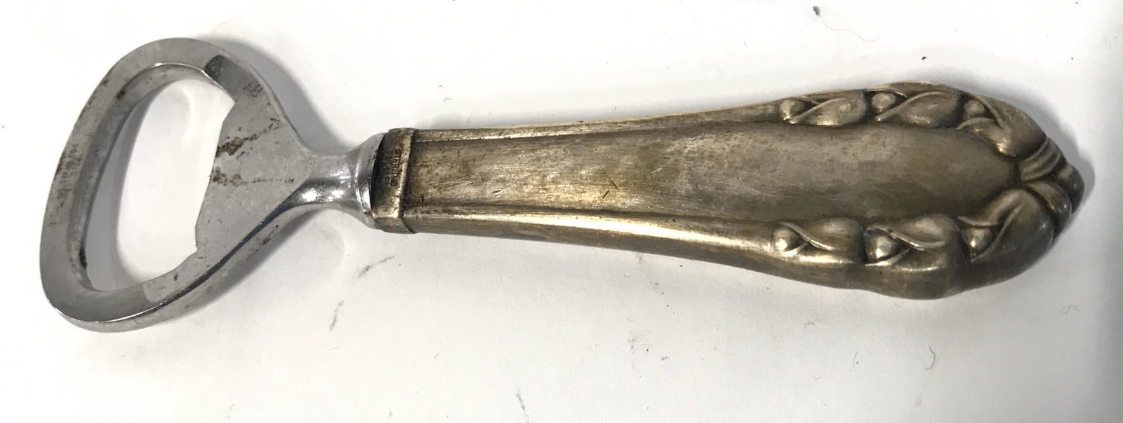 GEORGE JENSEN Sterling Silver Handle Bottle Opener: Top of handle is marked STERLING DENMARK. Top of piecemis marked GEORGE JENSEN. Bottle opener measures approximately 4.5 inches long 1.5 inches wide. Bottle opener, silver bottle opener, sterling silv