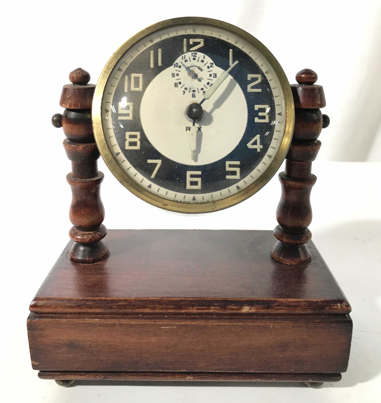 THE BURROUGHS COMPANY Vintage Desk Clock: Backside of clock has tag which reads THE BURROUGHS COMPANY. Clockface reads REX. Clock base is wooden. Clock frame is gold toned, possibly brass. Piece measures approximately 6 inches tall 5 inches w