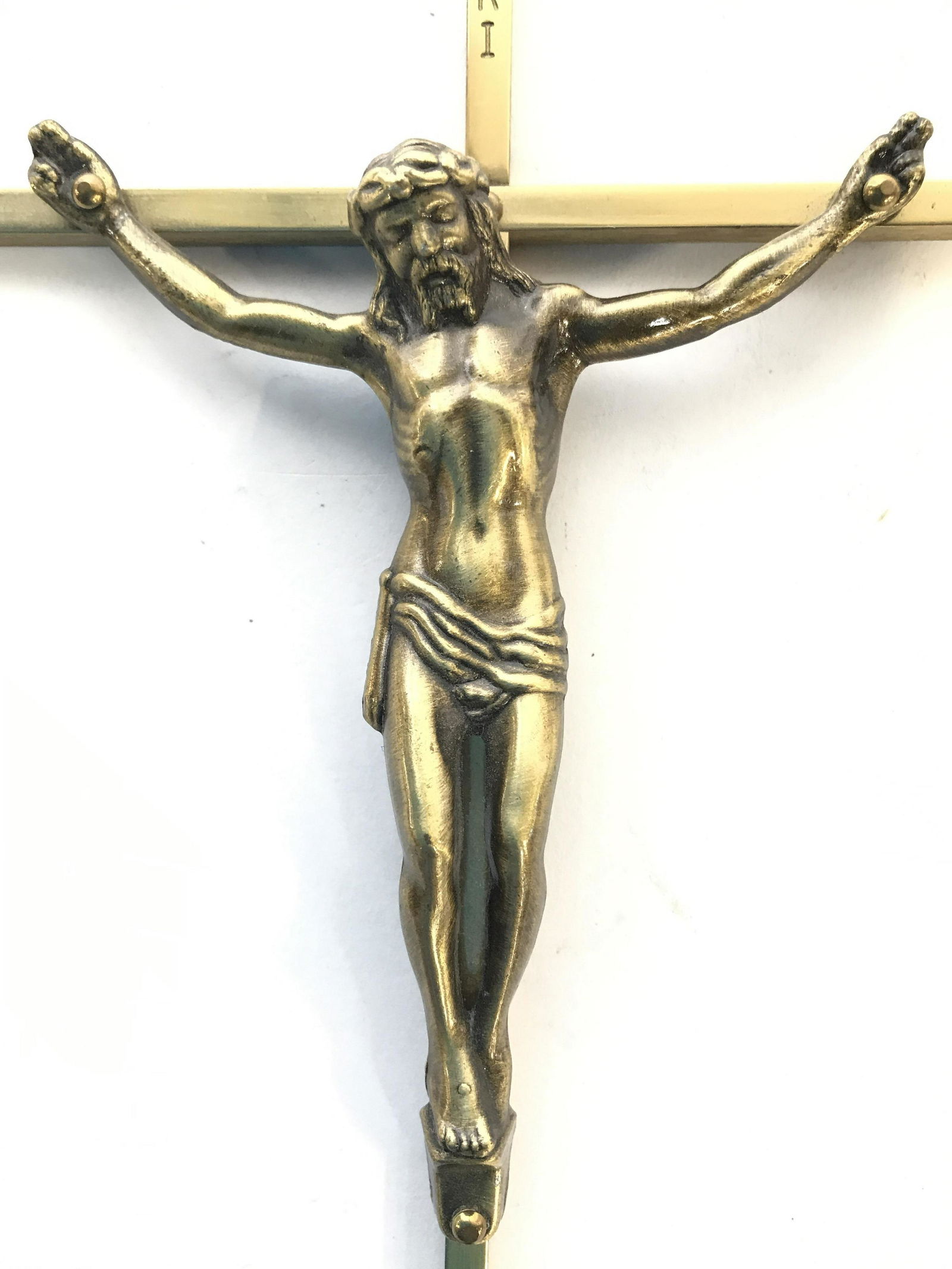 Vintage Gold Toned Crucifix: Crucifix is gold toned and appears to possibly be brass. Piece has depicts religious figure. Piece measures approximately 10 inches tall 5 inches wide. Crucifix, Religious Accessories. religious icono
