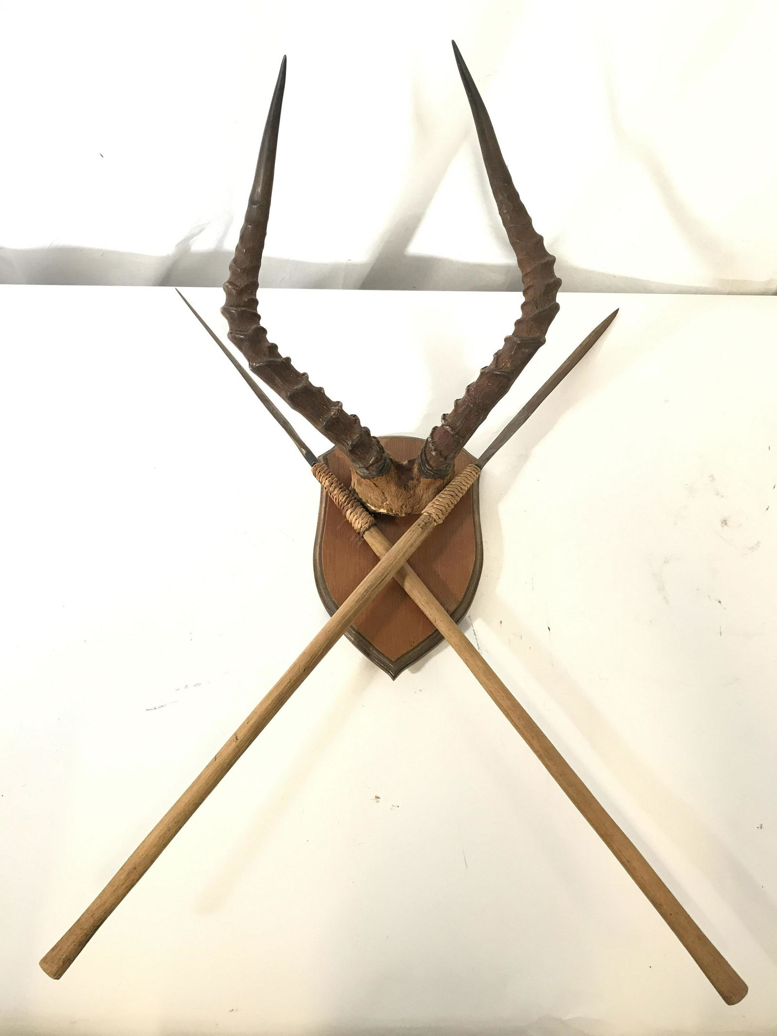 Vintage Wall Mount Horns & Spears: Piece has carved wooden wall mount with attached horns and crossing spears. Wall Mount Wall mounted horns, hunting memorabilia, collectible hunting accessories, wall mounted spears. home decor, wall f