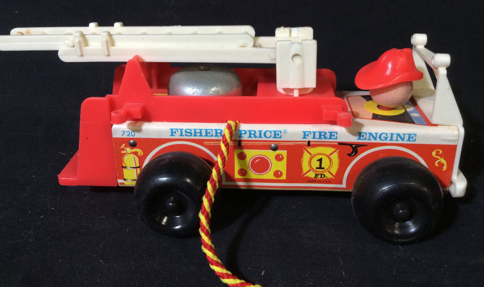 Retro Fisher Price Pull Fire Truck: With Bell that rings when pulled, some wear, measures approx 8 in by 4in by 4 in. collectible toy, vintage, retro toy, 4