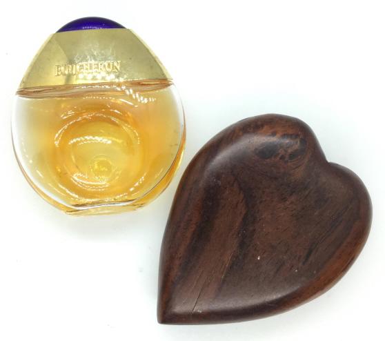 Lot 2 Ladies Fashion Accessories, Perfume, Mirror: One wooden case compact mirror. Crack to round mirror under glass. minor surface wear, 3 in by 2 1/2. One glass perfume bottle with gold toned metal lid and blue composite cabochon, partial contents,