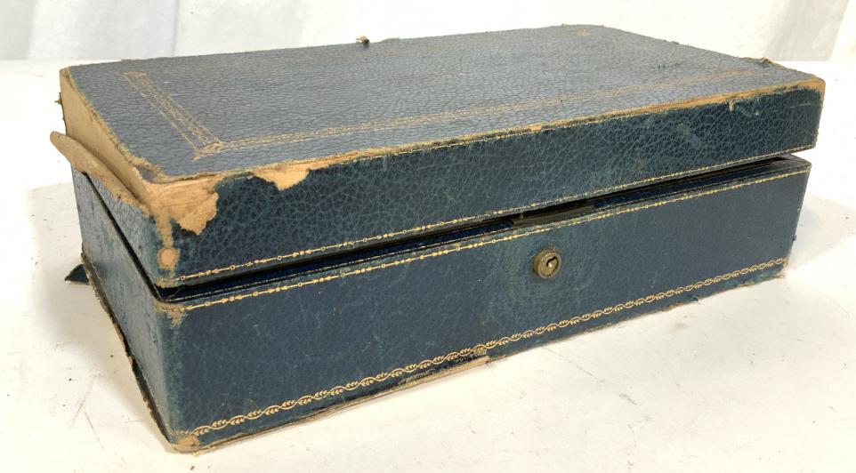L.E.A. Vintage Jewelry Box: This piece is a vintage L.E.A. Jewelry Box. The piece is bound in leather, which has been colored in teal tones, and features gold detailing. The compartment inside is lined with a velvet like fabric 