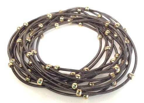 Set 12 Springing Stackable Bracelets: Dark toned metal spring bracelets with dainty gold tone accent beads. Wear as a large group, a few or just one. 2 pair are connected, otherwise all bracelets are individual. Fashion Accessory, Stackab