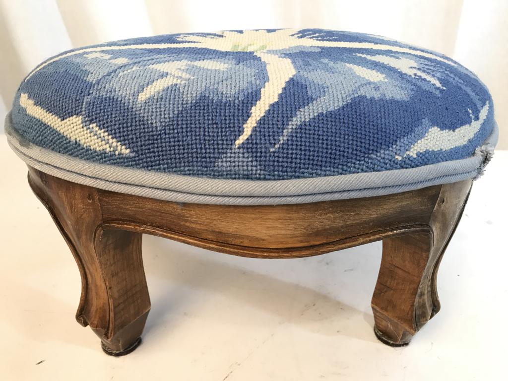 Antique Carved Wooden Footstool W Needlepoint Top: Cushion of Footstool is Needlepoint. Legs have carved wooden detail. Wooden portion of Footstool is antique. Needlepoint Area appears to be new. Piece measures approximately 12.5 inches long 7 inches 
