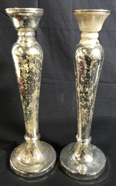 Pair POTTERY BARN Mercury Glass Candle Sticks: This is a pair of large Mercury Glass taper candlestick holders. The pieces originate in India, and are from POTTERY BARN. The pieces are double walled glass and silver toned. The pieces measure appro