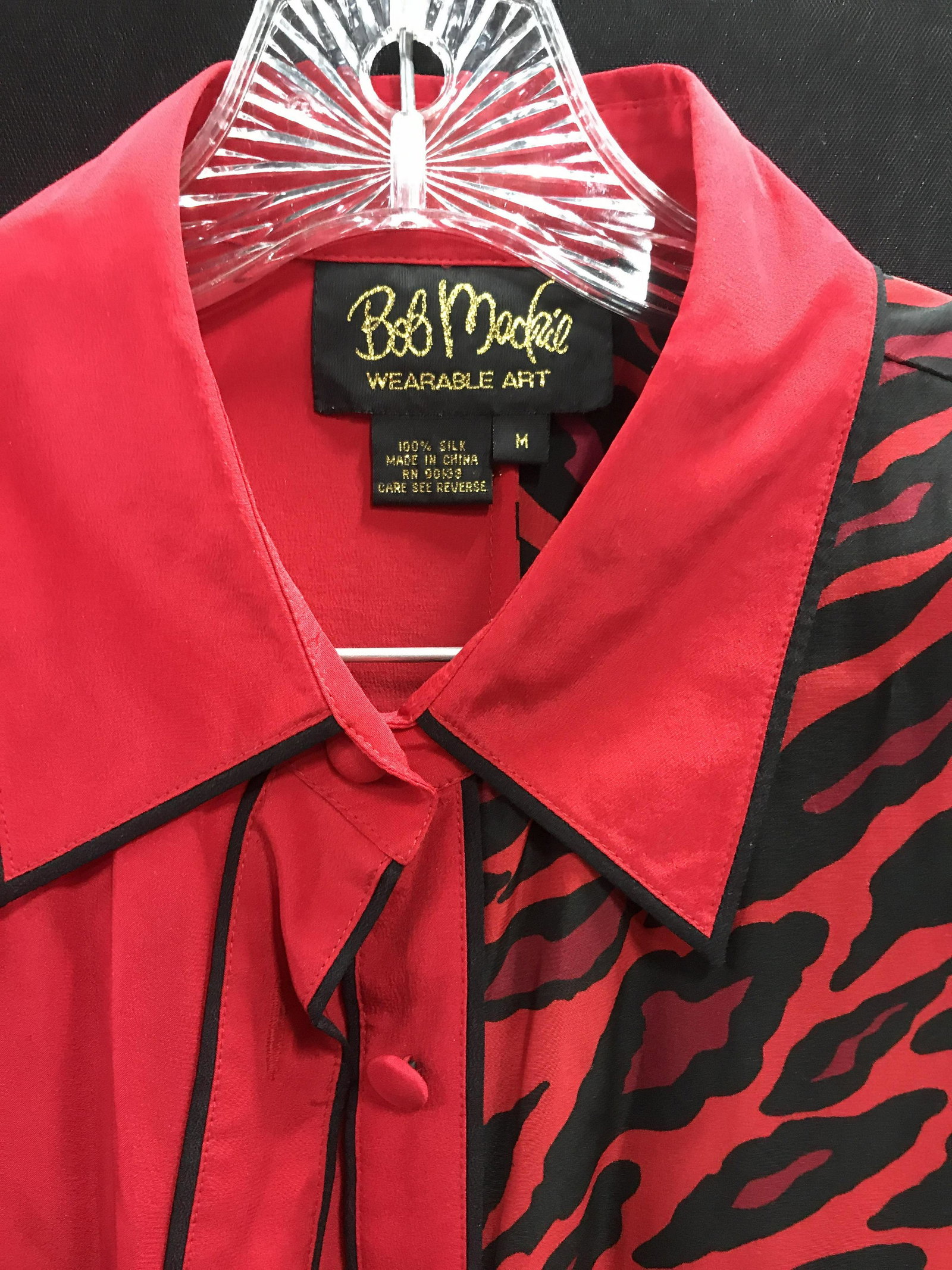 Silk Bob MACKIE Wearable Art Blouse , Sz M: From Bob Mackie’s high end Ready to wear collection. Red silk blouse, half solid color, half animal print. Buttoned cuffs, neck collar, app 29 in. Long. Size M Bob MACKIE, Luxury Designer Ladies Blo