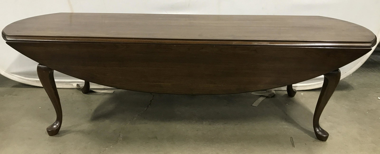 Vintage Wooden Cabriole Leg Drop Leaf Coffee Table: Coffee table is chocolate toned. Piece has 4 carved wooden cabriole legs. Table has 2 drop leafs. Coffee table, wooden coffee table, brown coffee table, drop leaf coffee table, Cabriole leg coffee tab