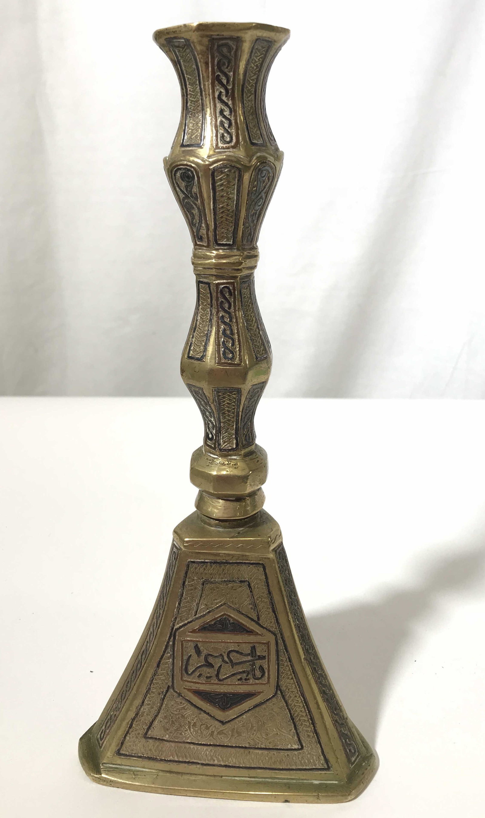 Vintage Etched Brass Candlestick Holder, Syria: This is a vintage brass candlestick holder. The piece is hand made and hand-painted, the candlestick features intricate detailing. The piece shows signs of wear consistent with age and use. The piece 