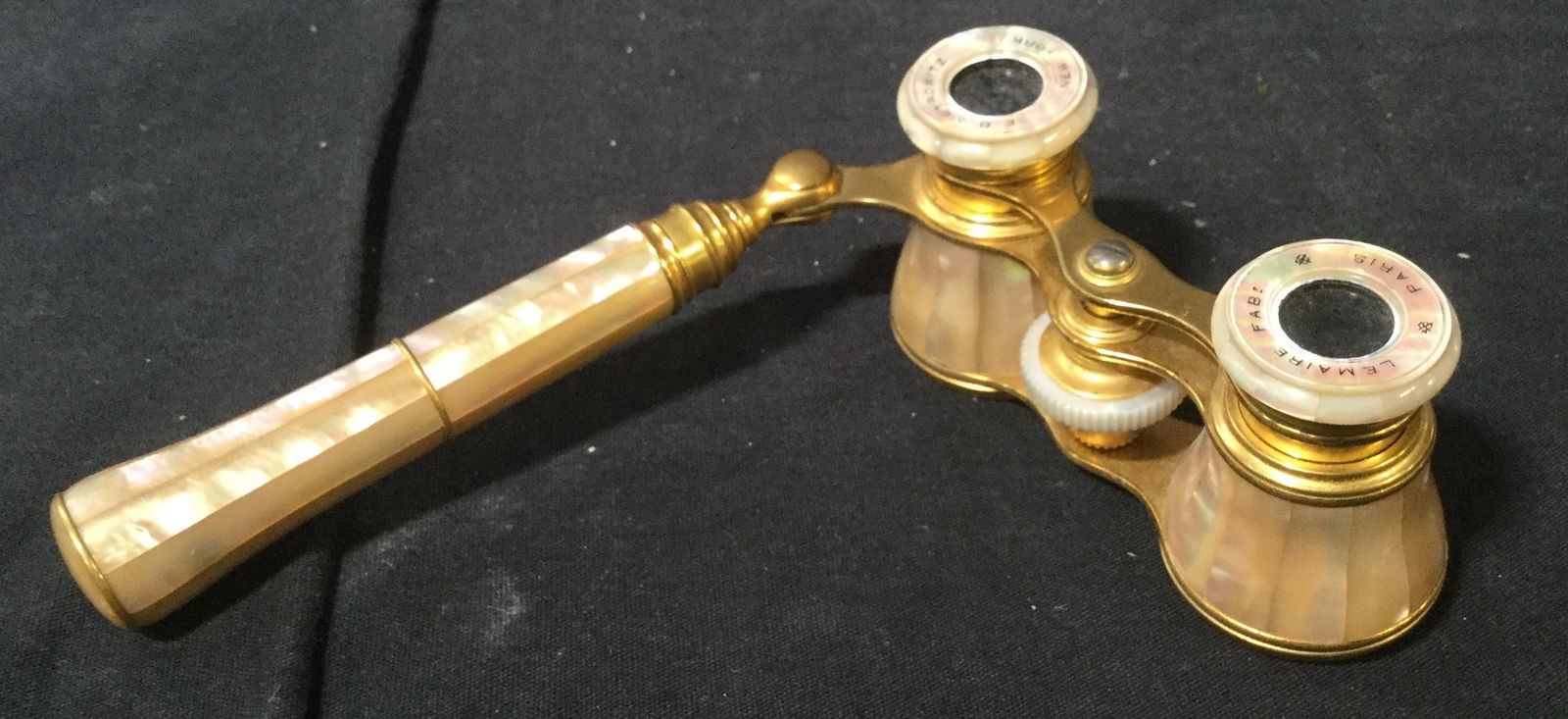 Vintage EB MEYROWITZ Nacre Opera Glasses: This is a vintage, possibly antique, pair of Opera glasses. The piece is crafted from nacre, and brass. The piece was crafted in FRANCE. The piece measures approx 2inches H and 4 inches W, the handle