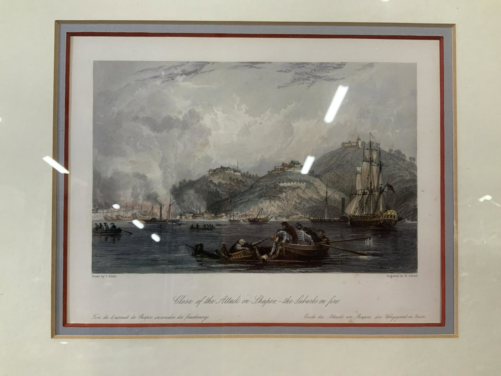 Double Engravings of Scenes from The Opium Wars: Two Engravings of scenes from The Opium Wars in China, both double matted in blue and white with red and yellow borders, gilt wood frame painted blue, some chips to frame, some foxing to white matting