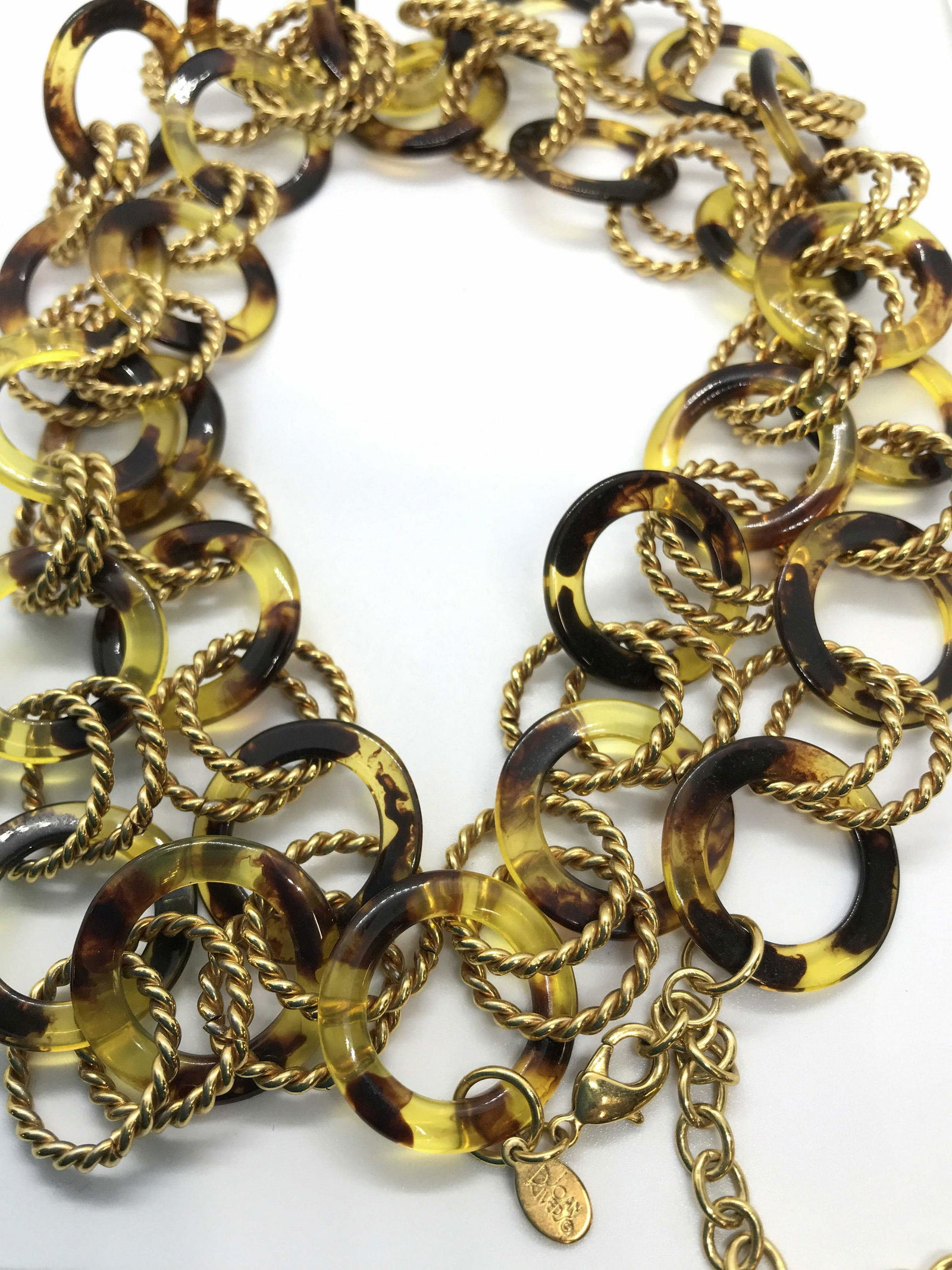 Round Linked Joan Rivers Fashion Necklace: Adjustable length necklace, lobster clasp, Signed Joan Rivers on Charm, 34-36.5 in. Tortoise shell style composite linked with twisted gold tone links. Contemporary Style Fashion Jewelry, Joan Rivers