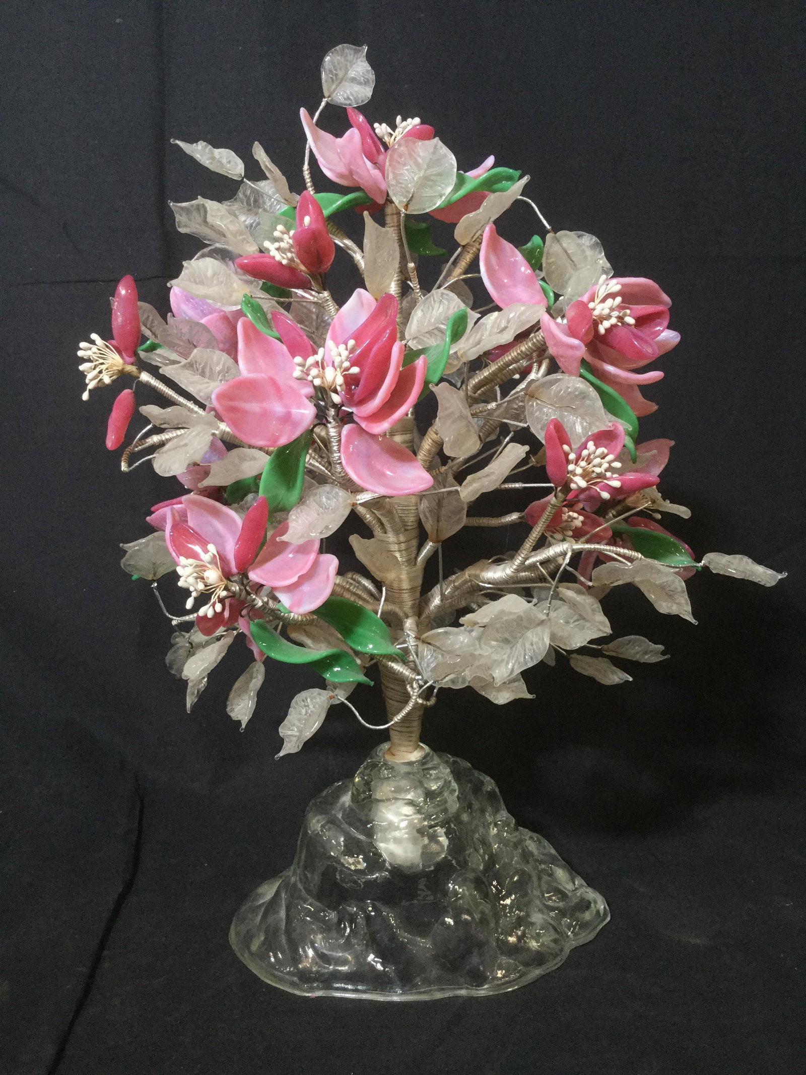 Vintage Glass Petal Floral Bouquet: This piece is a vintage floral bouquet, the piece is crafted from glass, wire, and fabric. The bouquet is set in a glass base. The piece measures approx 15 inches H and 10 inches W. There is some wear