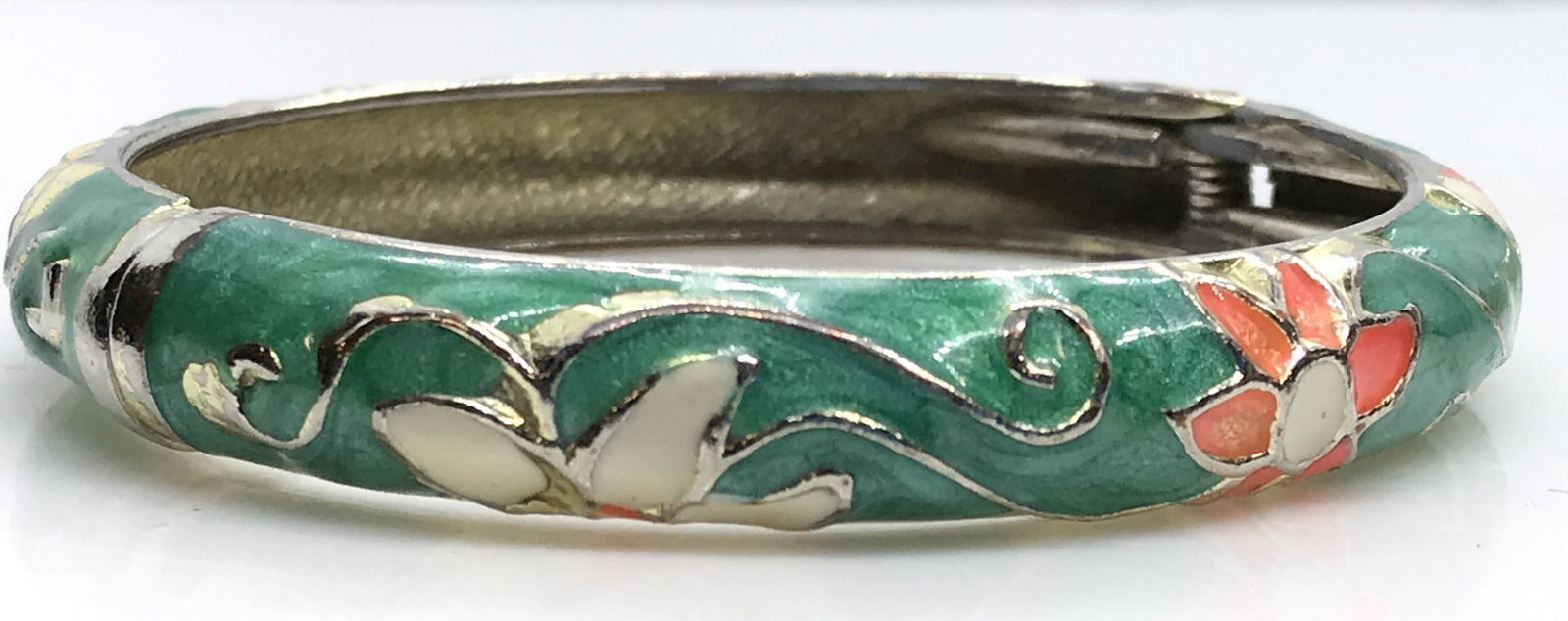 Pair Cloisonné RG Hinge Bangle Bracelets, Signed: Designer Chinese Cloisonné. Aqua Green Enamel, 1 with rose gold tone outline of florals. Rose gold tone metal on undersides, designer signed ‘ Jiu Long Xing’. 2 3/4 in. Bangles hinge open. Other