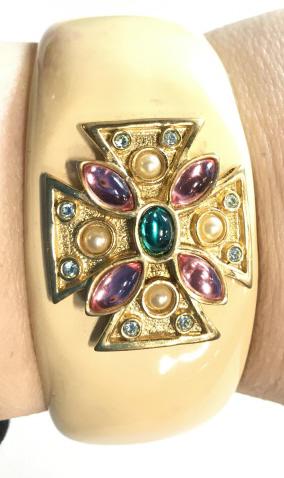 Joan Rivers Bejeweled Celtic Cross Enamel Bangle: Vintage Joan Rivers Collection. Hinged Bangle with security snap, signed on disc, YG toned Interior & Embossed Crystal And faux gem cross at center. Opening 2.5 in long, Bangle width app 1 in. Vintage