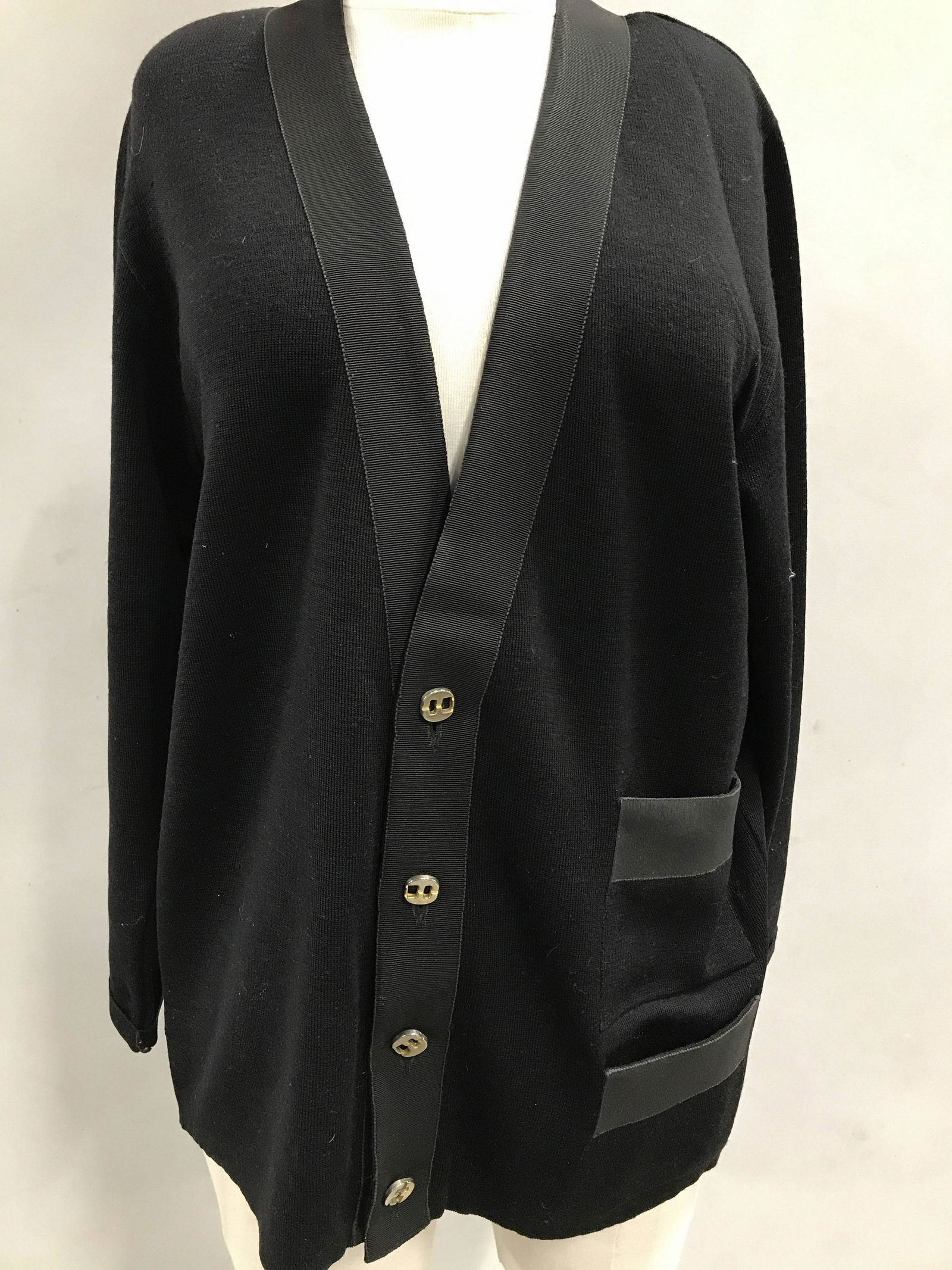 Salvatore Ferragamo Button Down Knit Sweater: Black Knit Blazer Style Sweater, 4 front buttons, Savatore Ferragamo label, Made In Italy, size Medium. 26 in. long. 2 front pockets. Possibly Cotton Nylon combo. No fabric issues. Property of Upper E