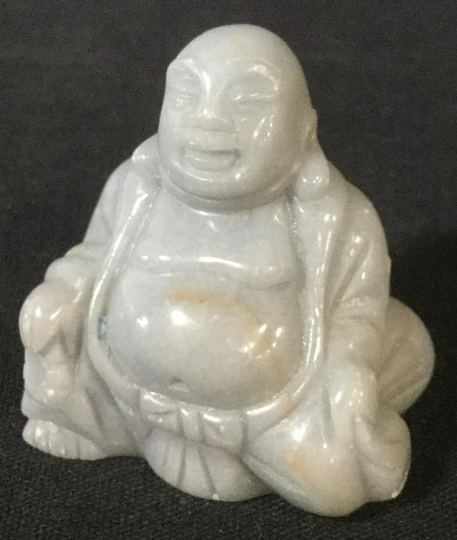 Carved Polished Stone Miniature Buddha: This is a carved miniature stone Buddha. The piece has been polished to produce a smooth, glossy texture. The piece measures approx 1.5 inches H and 1.5 inches W. There is some wear present due to exp