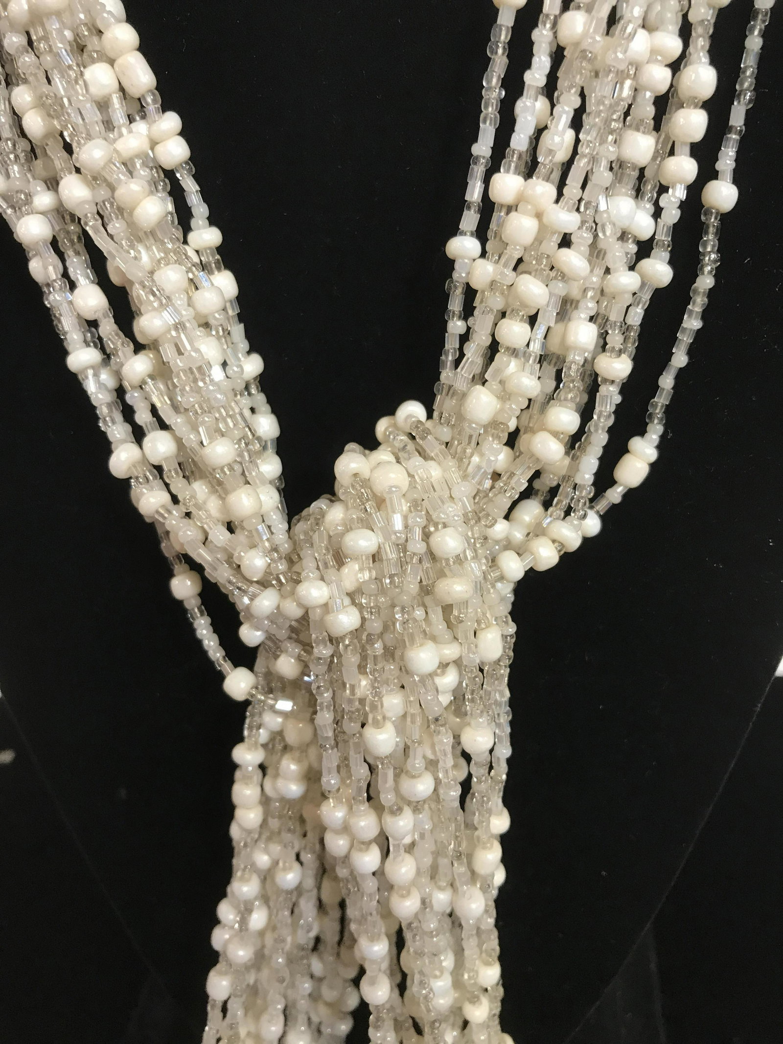 Multi Strand Beaded Necklace/ Acc.: Faceted center anchor AB 12 mm bead. Over 10 strands of hand strung seed beads- clear & pearlescent. Total length 42 in. Up Cycle Beads, tie strands to create tassel. Beaded Accessory, Multi purpose j