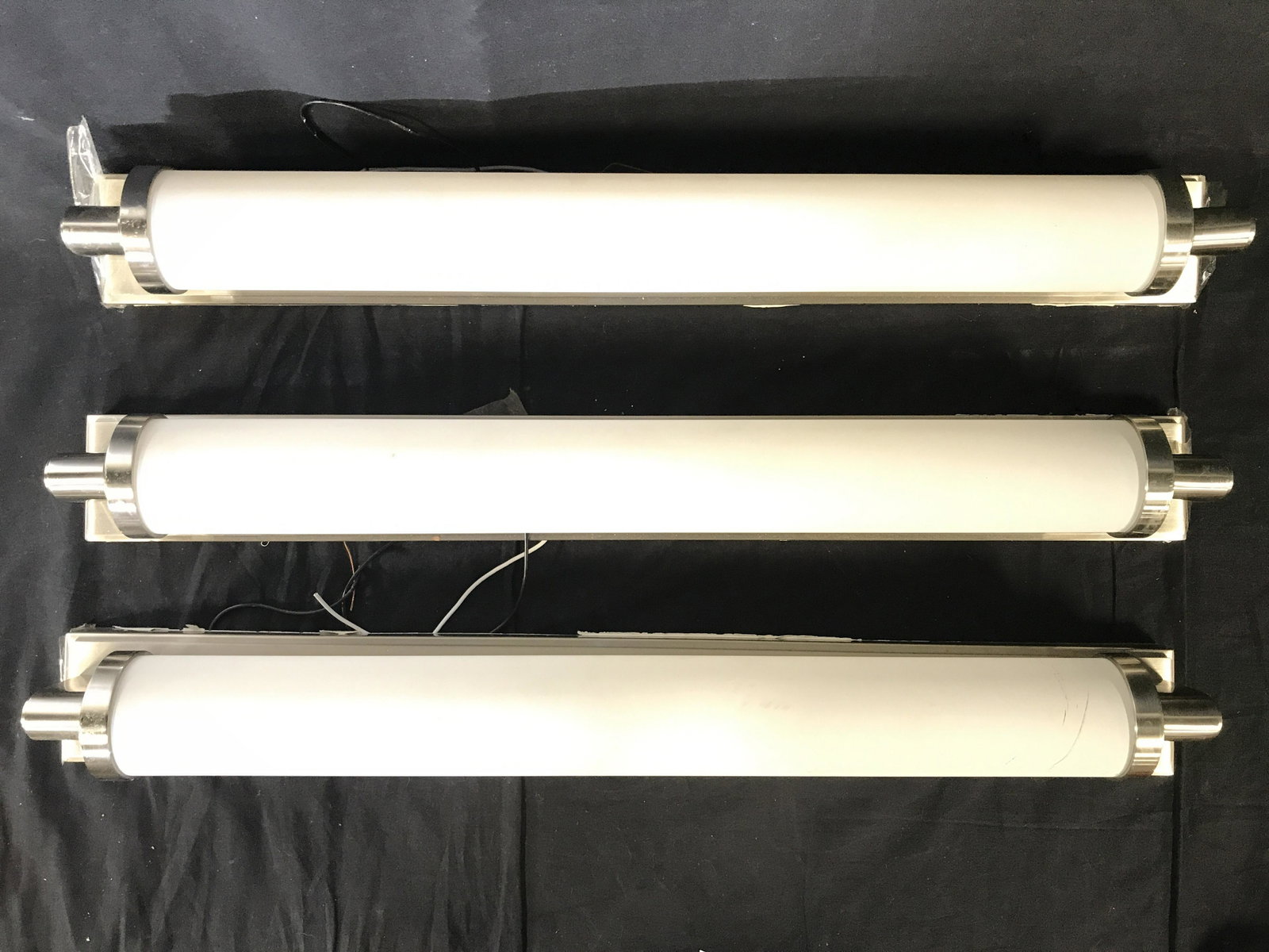Set 3 DESIGN WITHIN REACH Wall Sconce Lights: Lot includes 3 wall Sconce lights. Each are cylindrical in shape. Each measures approx 29 inches tall 3.5 inches tall , 4.5 inches deep. Wall Sconce lights, design within reach lights, Sconce lights, 