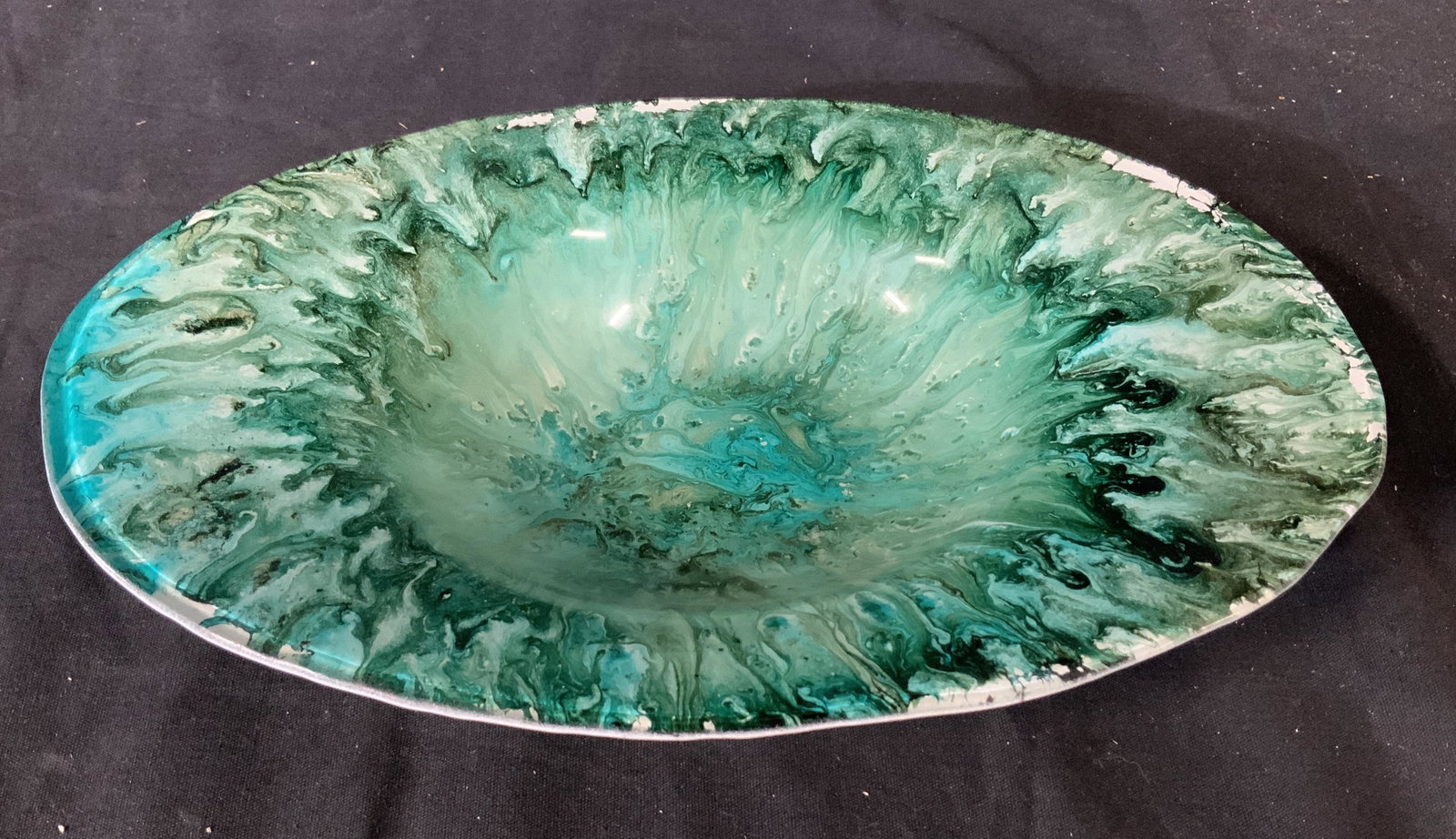 Blue and Green Swirled Painted Dish: Blue and green dish table top accessory. Painted glass with mix colored drip and swirling pattern. 11 inches long, 7 inches across, 2 inches deep. Ocean like mix of blues and greens evoke an in studio