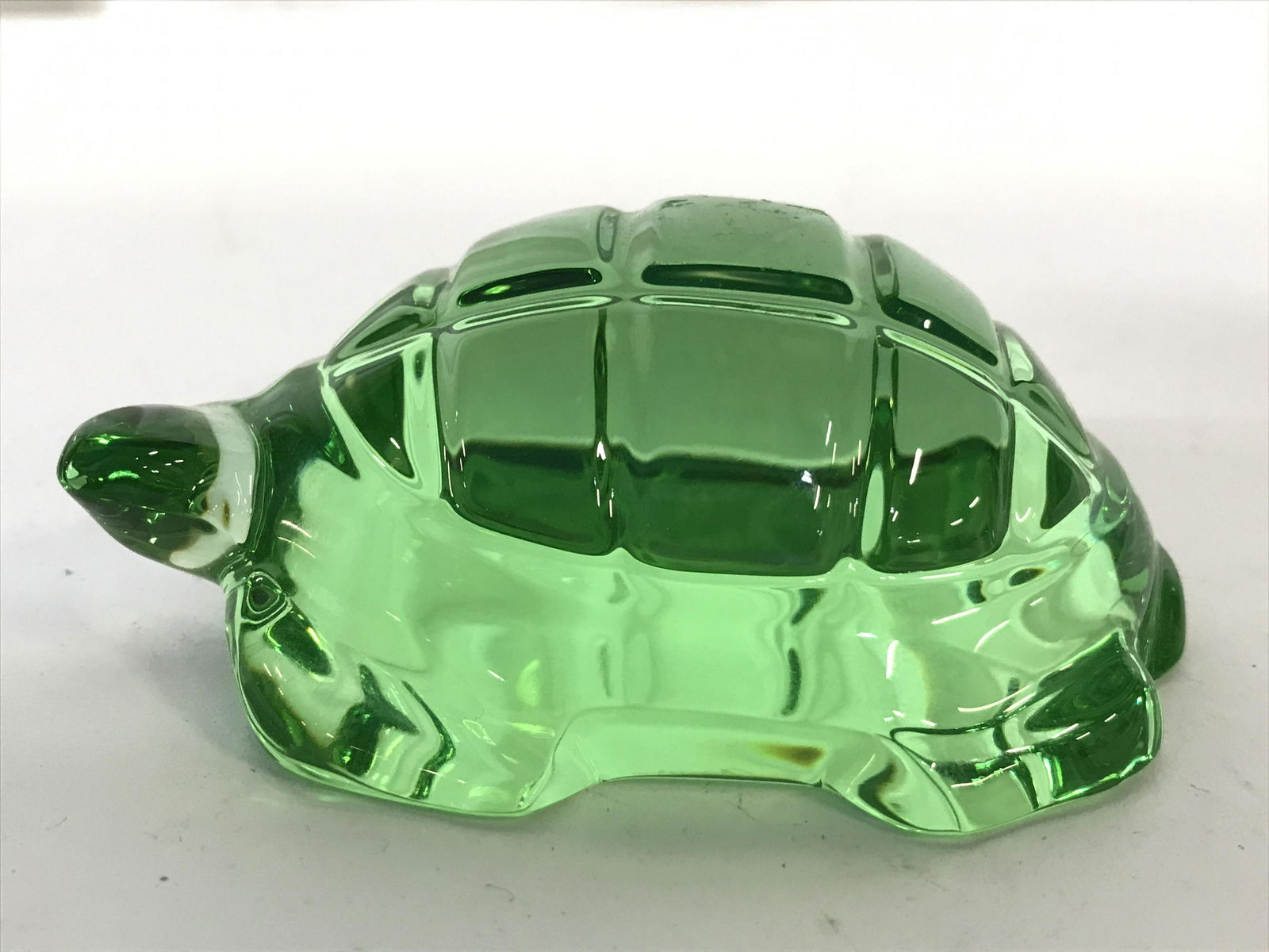 BACCARAT Green Toned Crystal Turtle: Underside of piece is signed BACCARAT. Piece is green toned. Turtle is crystal. Piece measures approximately 4 inches long 2.5 inches wide 1.5 inches tall. BACCARAT Turtle, Crystal turtle, green turtl