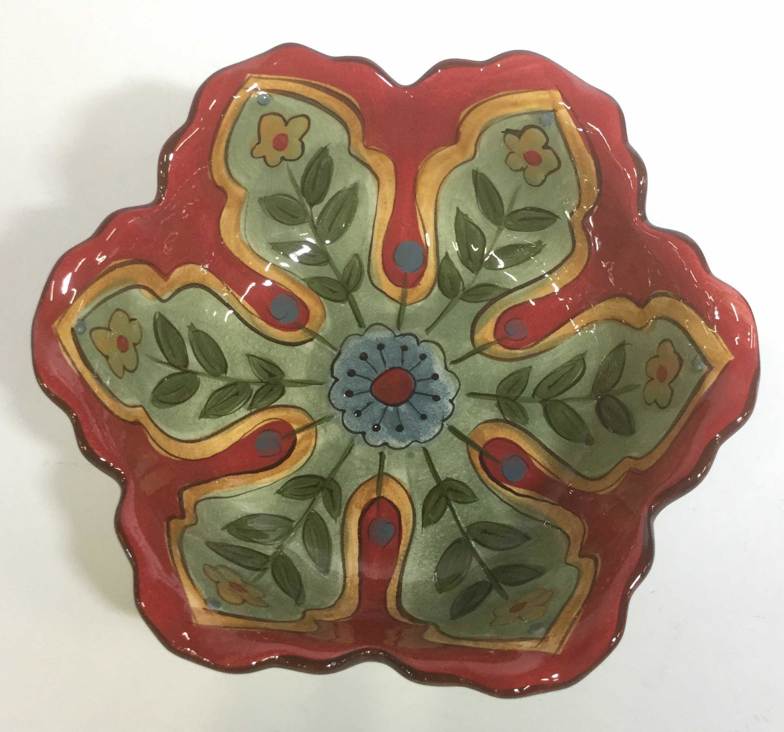 Pier1 Hand Painted Earthenware Decorative Bowl: This is a handmade decorative carynthum bowl. The piece depicts and is in the shape of a blooming flower. The piece measures approx 3 inches H, and 10 inches W. The piece is new and unused. Underside 
