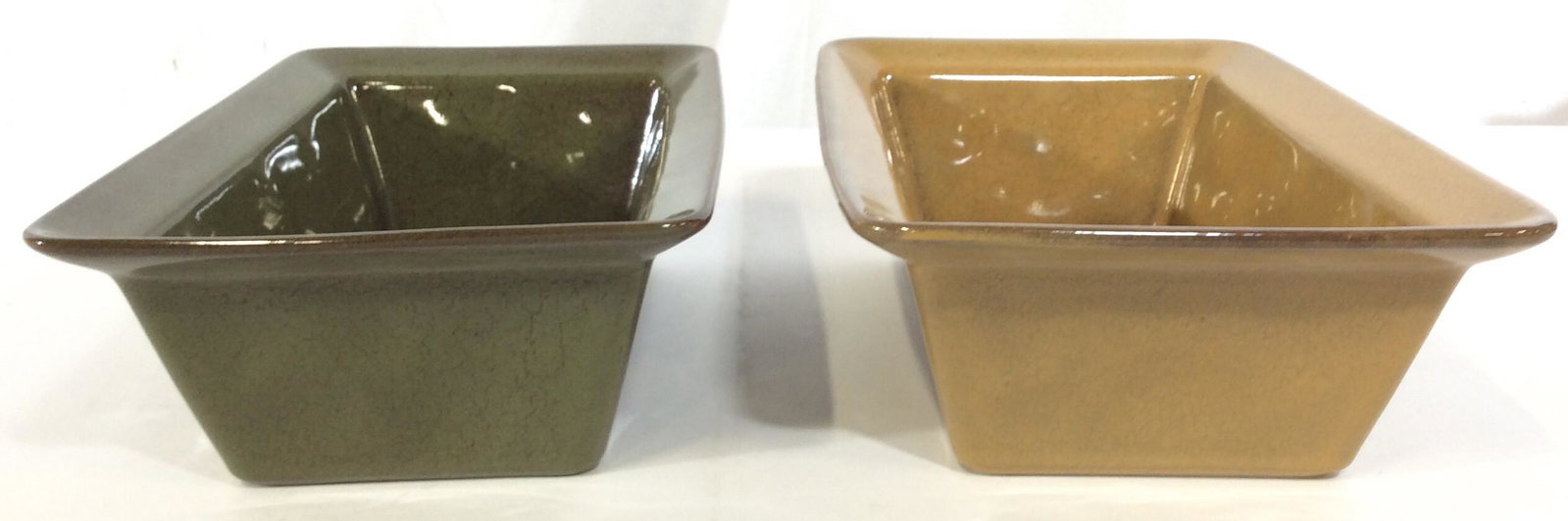 Lot 3 Ceramic Bread Pans, Dish ware: This lot includes three ceramic bread pans. Each pan is a different color and style. The largest piece measures approx 3.25 inches H and 11 inches W. The pieces are new and unused. The underside of on