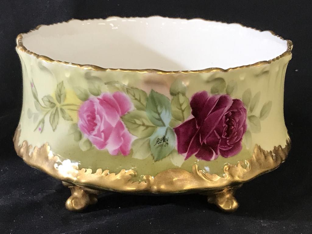 Hand Painted T&V Limoges Footed Porcelain Bowl: Tresseman & Vogt vintage (possibly antique, c 1920s) bowl/planter. Light green and pink roses, heavy gilt on rim, feet and lower border. Signed, appears like ‘Roby’. Underside stamped in cranberry