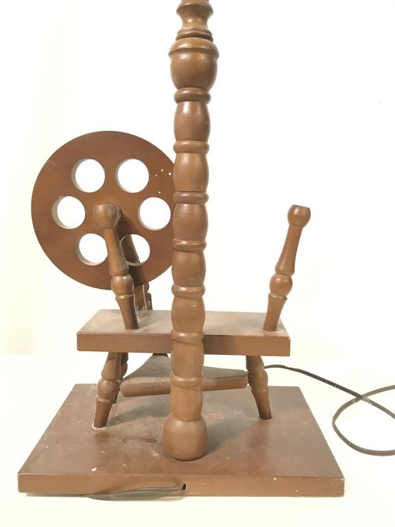 Mid Century Spinning Wheel Wood Lamp, c.1950s: Rotating spin wheel with foot lever, on wood plaque, next to light on pole. Base measures app 10 x 7 in. Ht is 19.5 in. (W/O Bulb). Working condition. Missing spin wheel parts, does not affect functio