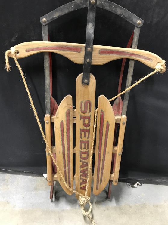 Vintage SPEEDWAY Wooden Children’s Sled: This is a vintage, possibly antique, wooden sled with metal runners. The piece is from SPEEDWAY. The piece includes a rope that allows for steering. The piece measures approx 34 inches long, and 21 in